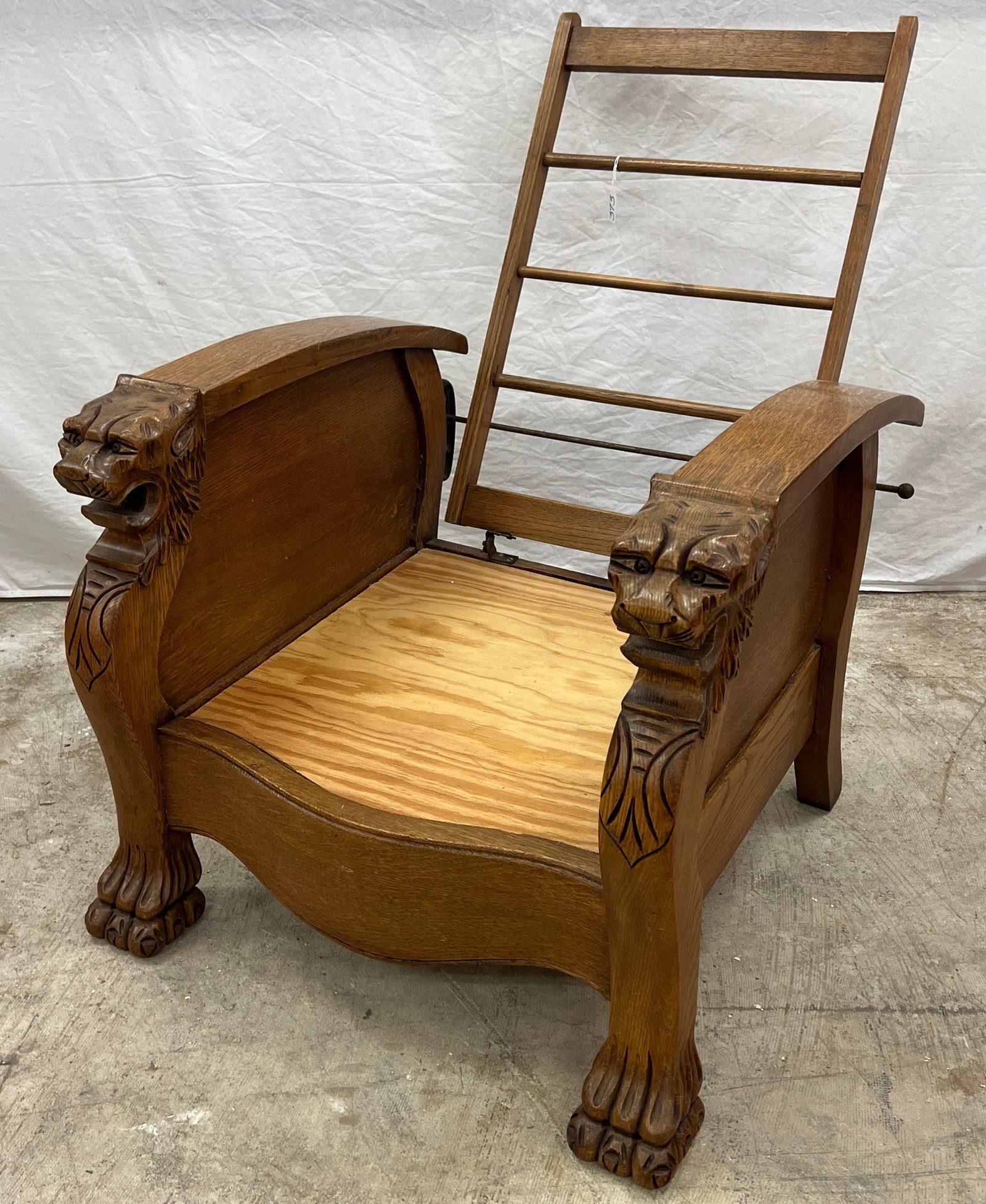 Griffin Carved Morris Chair: An elaborately griffin carved Morris chair with claw feet. It has been professionally refinished and just needs a cushion. It measures 39" tall X 27" across X 23" deep.