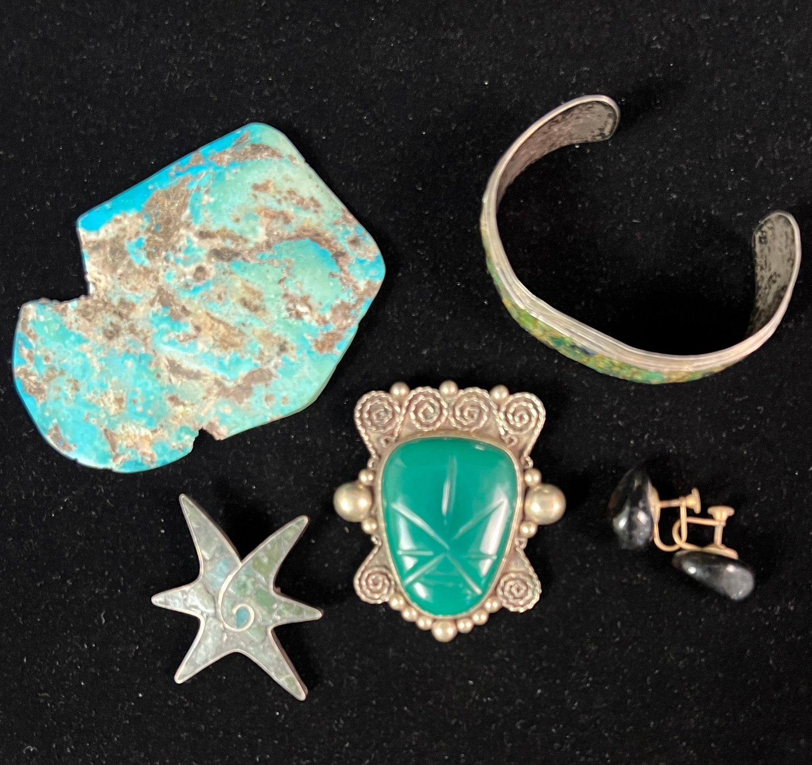 Group of Sterling Southwest Jewelry: A group of sterling Southwest jewelry to include a silver and carved green onyx brooch, a sterling turquoise cuff bracelet, sterling turquoise star pin, a pair of smokey quartz earrings and 2 flat pie