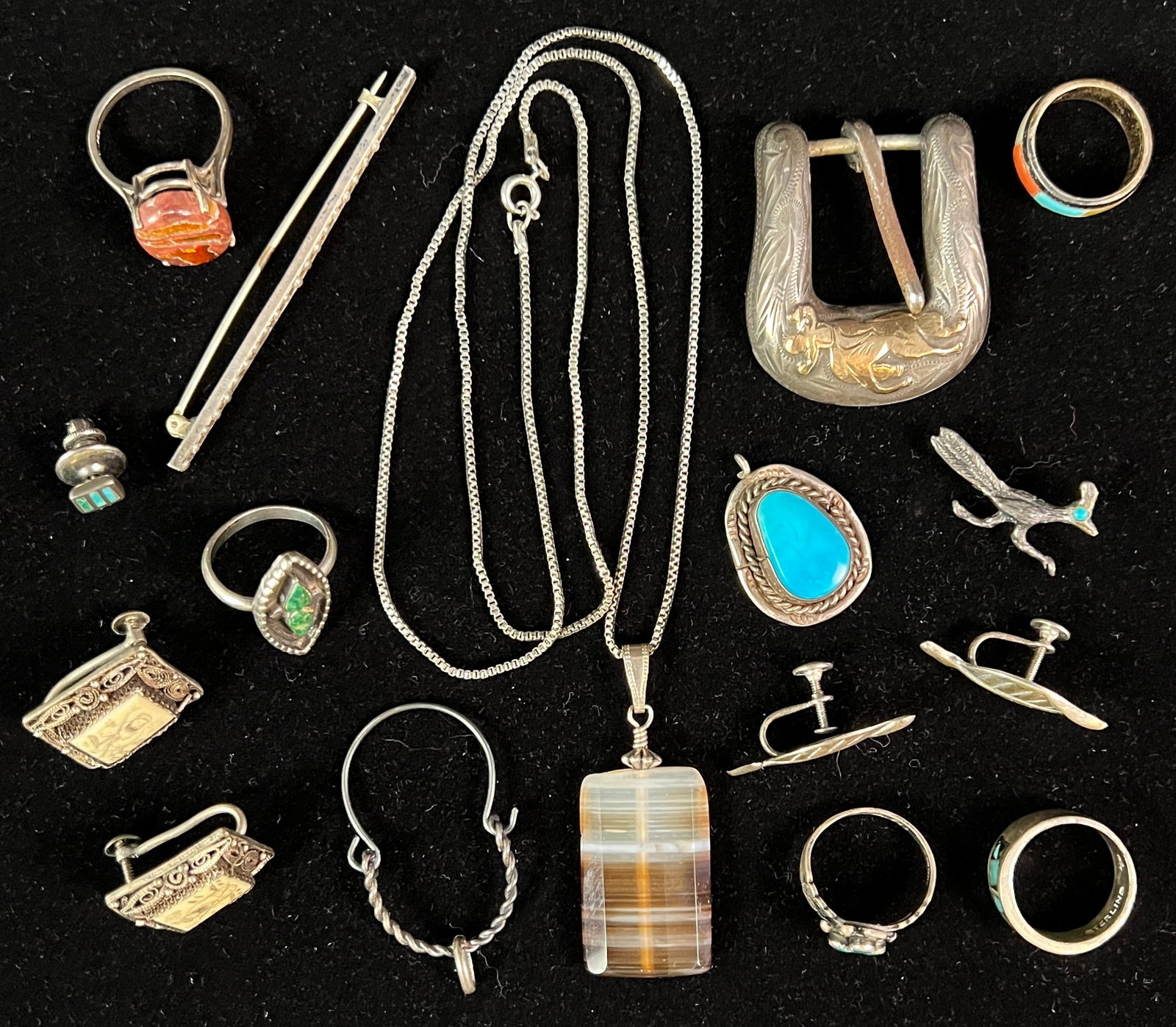 Southwest Sterling Lot: A Southwest sterling lot to include turquoise pendant, sterling ring with reddish caramel stone (sz 8.5), sterling ring with inlayed multicolored stones (sz 6), sterling ring with green turquoise (sz 