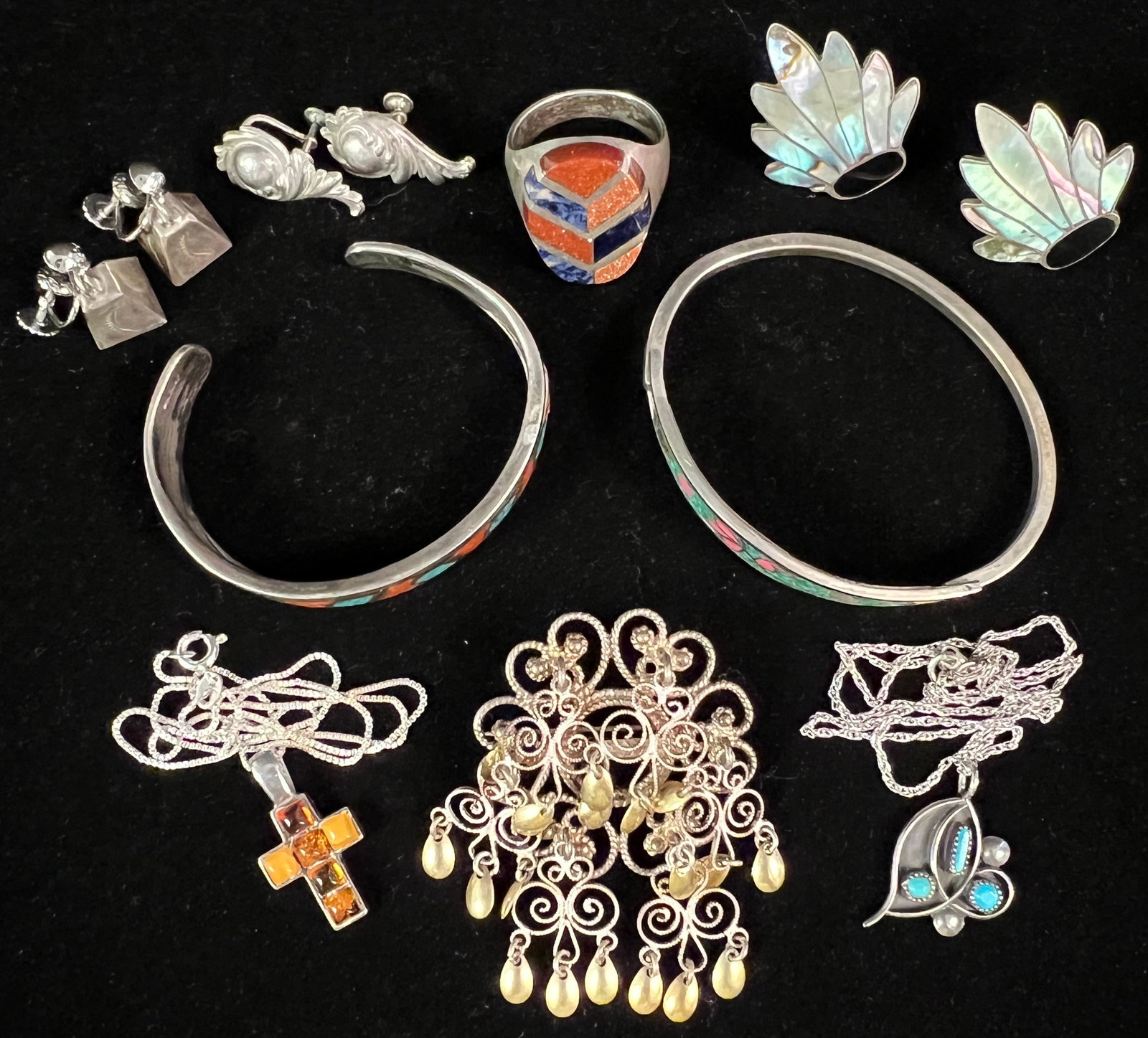 Sterling & Silver Group: A sterling and silver group to include a man's ring with lapis lazuli and glittering orange goldstone (sz 12), pair of sterling and mother of pearl leaf screw back earrings, pair of sterling bell scre