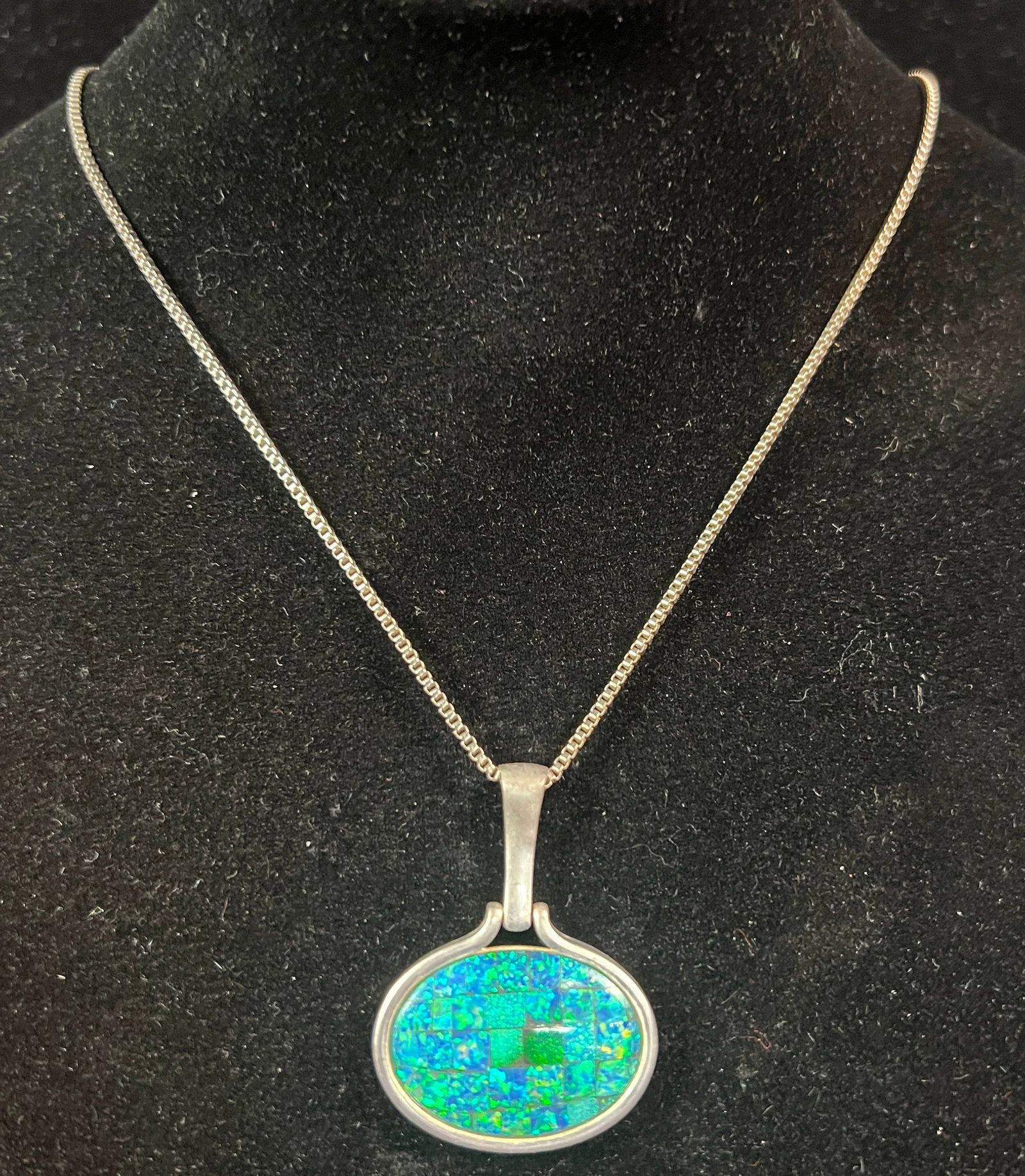 Sterling Southwest Indian Lot: A sterling southwest Indian lot to include a large pendant with agate stone, a brooch, screw back wing earrings, sparkly pendant and chain, mother of pearl and sterling earrings, sterling and coral st