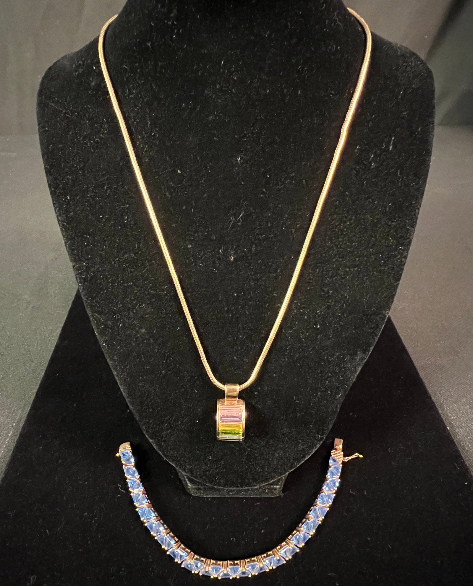 Sterling Bracelet and Necklace: A sterling and blue stone bracelet (7" long) along with a rainbow baguette stones pendant marked 'SETA' on chain (18" long). Both in great condition.