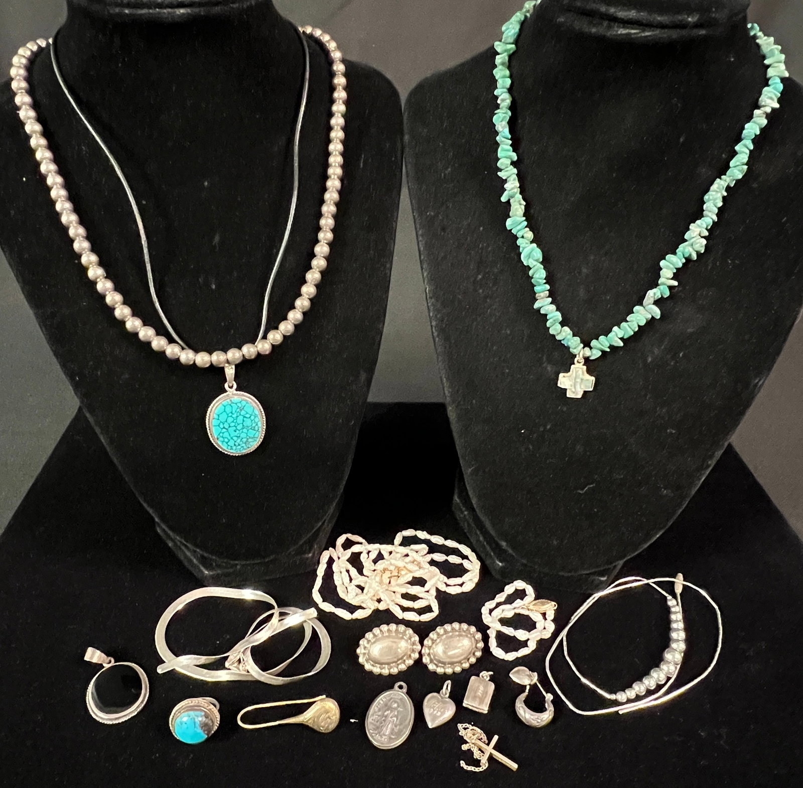 Group of Sterling: A group of sterling to include a turquoise and silver pendant, a jet and silver pendant, a pair of pierced sterling earrings, turquoise ring (sz 1), a beaded silver necklace and more. All in good cond