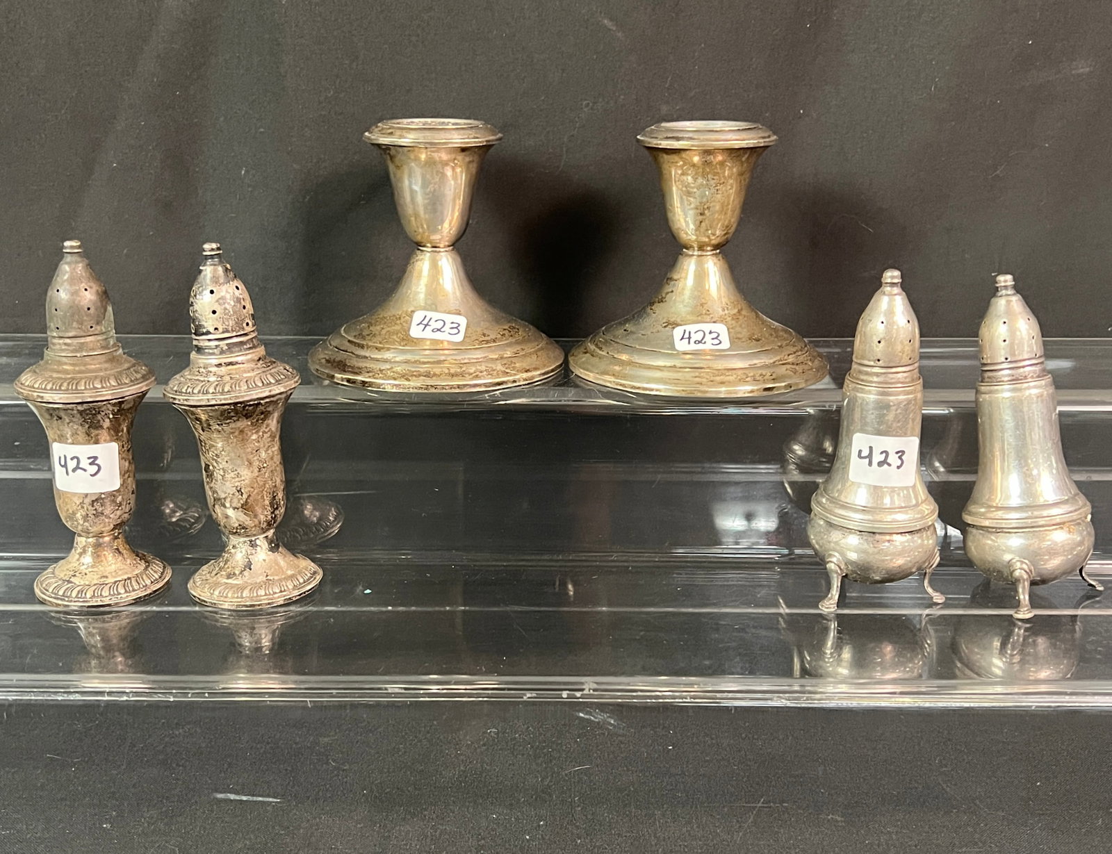 Pair of Sterling Candlesticks and Salt & Peppers: A pair of weighted Gorham sterling candlesticks that measure 3.5" tall X 3.75" round at the base. Also included are 2 pairs of sterling salt and pepper shakers in as found condition.