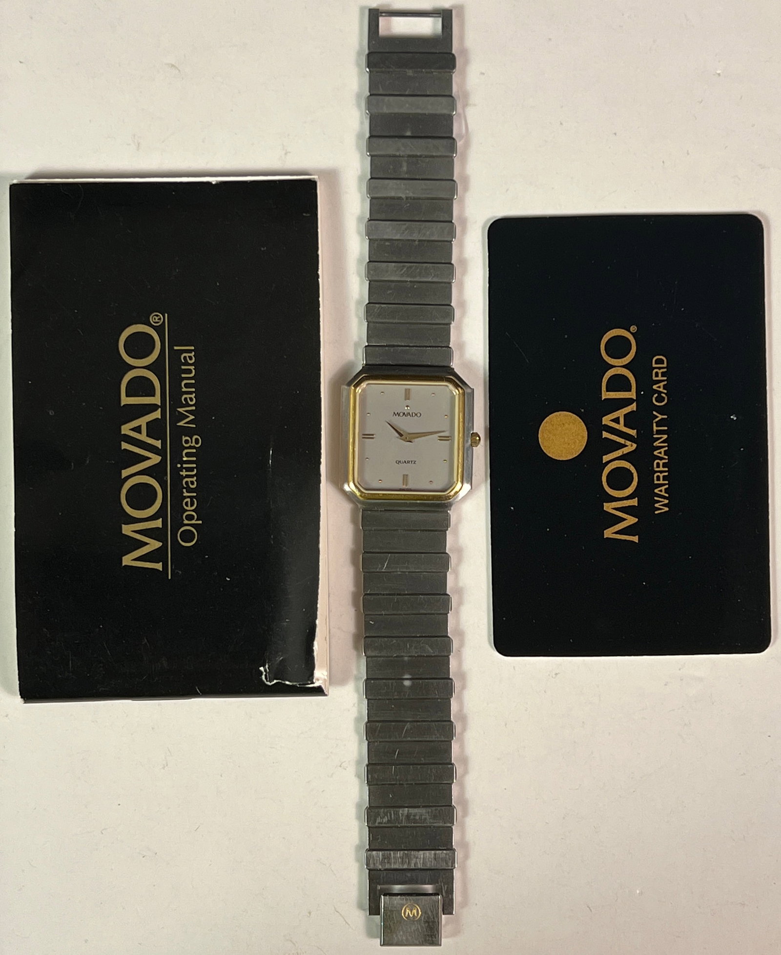 Movado Men's Watch: A Movado by Quartz men's watch with warranty card and operating manual, was purchased in 1996.