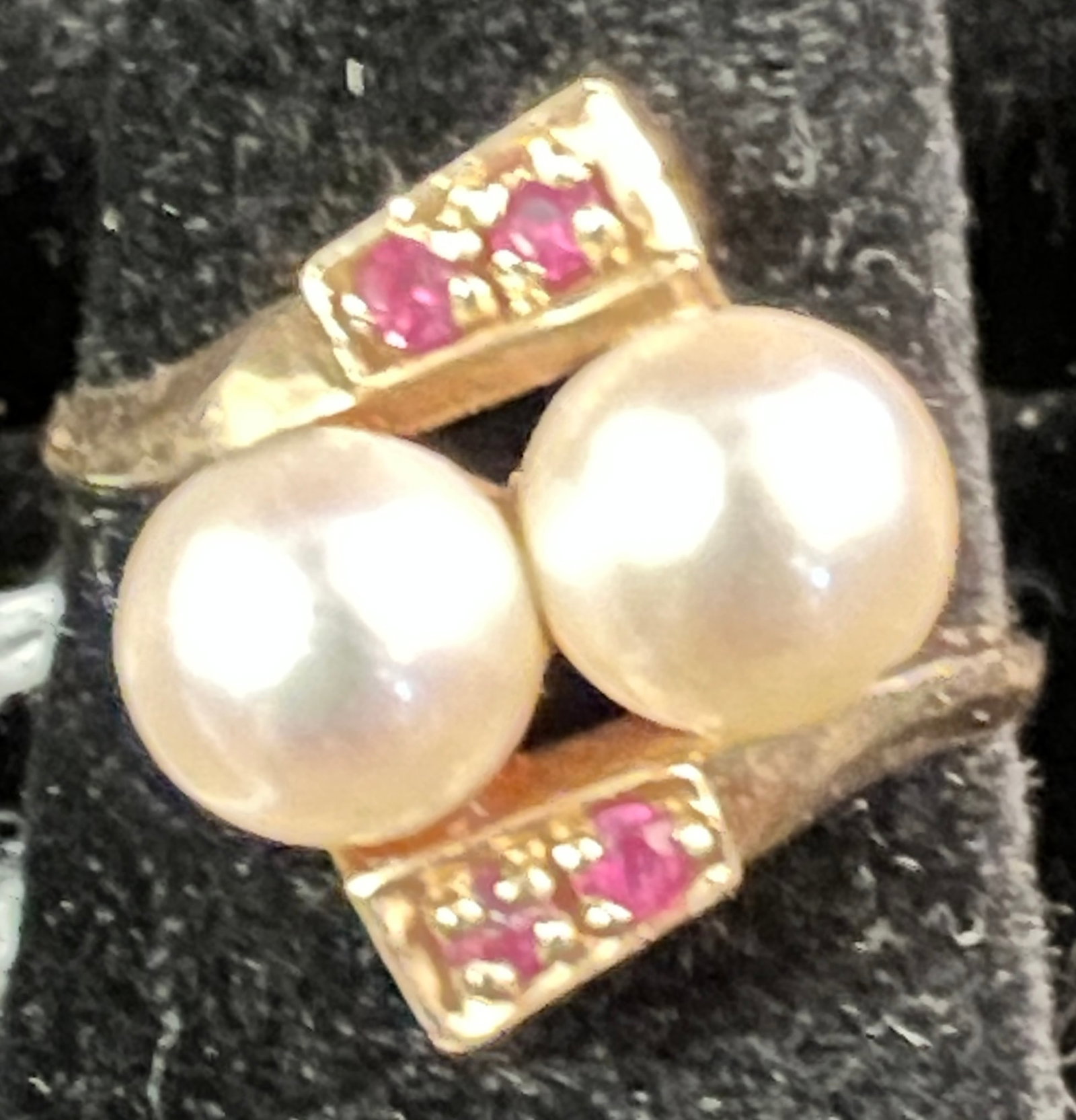 14k Pearl and Ruby Women's Ring: A 14K women's cocktail ring featuring two large pearls and 4 rubies. Ring is a size 8 and weighs 4.35 grams.