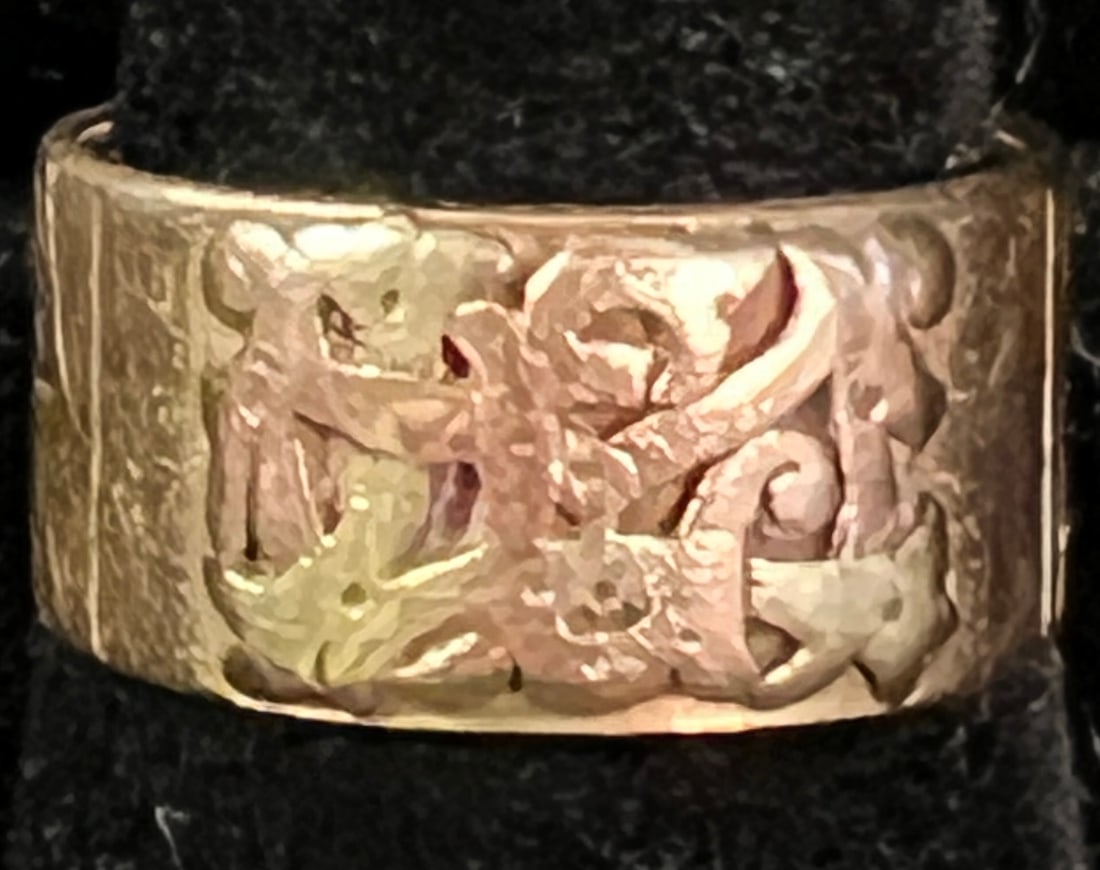 14K Gold Band with Black Hills Gold Accents: A 14k gold band ring with filagree black hills gold. Ring weighs 8.68 grams and is a size 7.5.