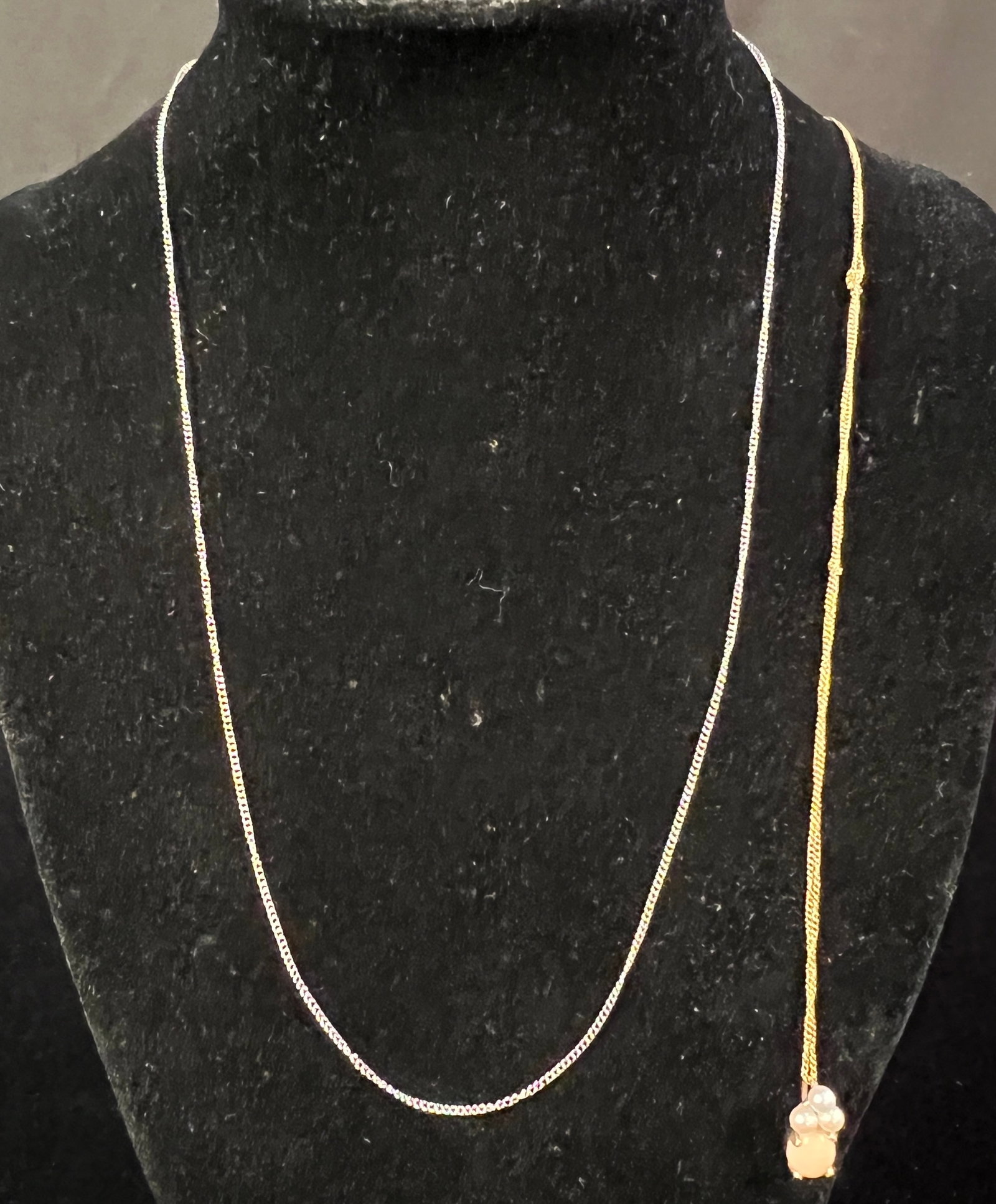 Two 14K Gold Necklaces: A 14K gold coral and pearl pendant necklace along with a 14K white gold chain. Both is good condition. Weight of white gold chain 0.81g and weight of the coral and pearl necklace is 1.77g and has