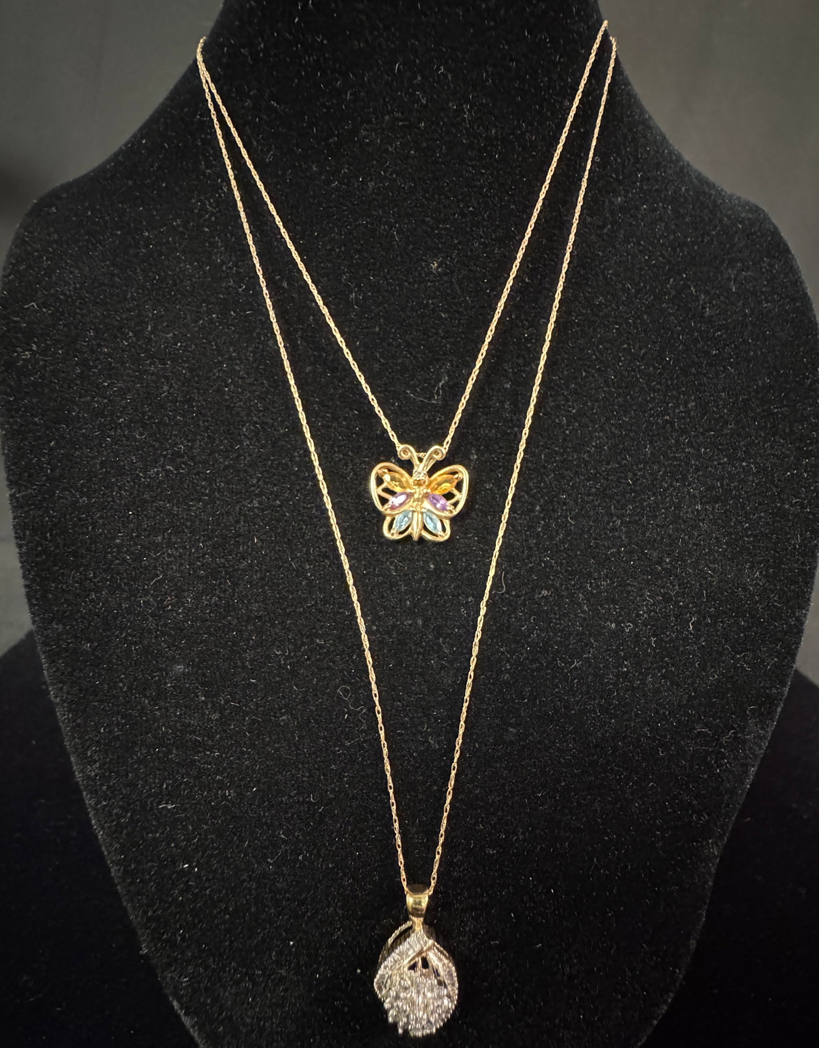 Two 10K Gold Ladies Necklaces: Two 10k gold ladies necklaces. One necklace features a pendant set with single cut and baguette diamonds, second necklace features a butterfly pendant with citrine, Amythyst and aquamarine stones. Tot