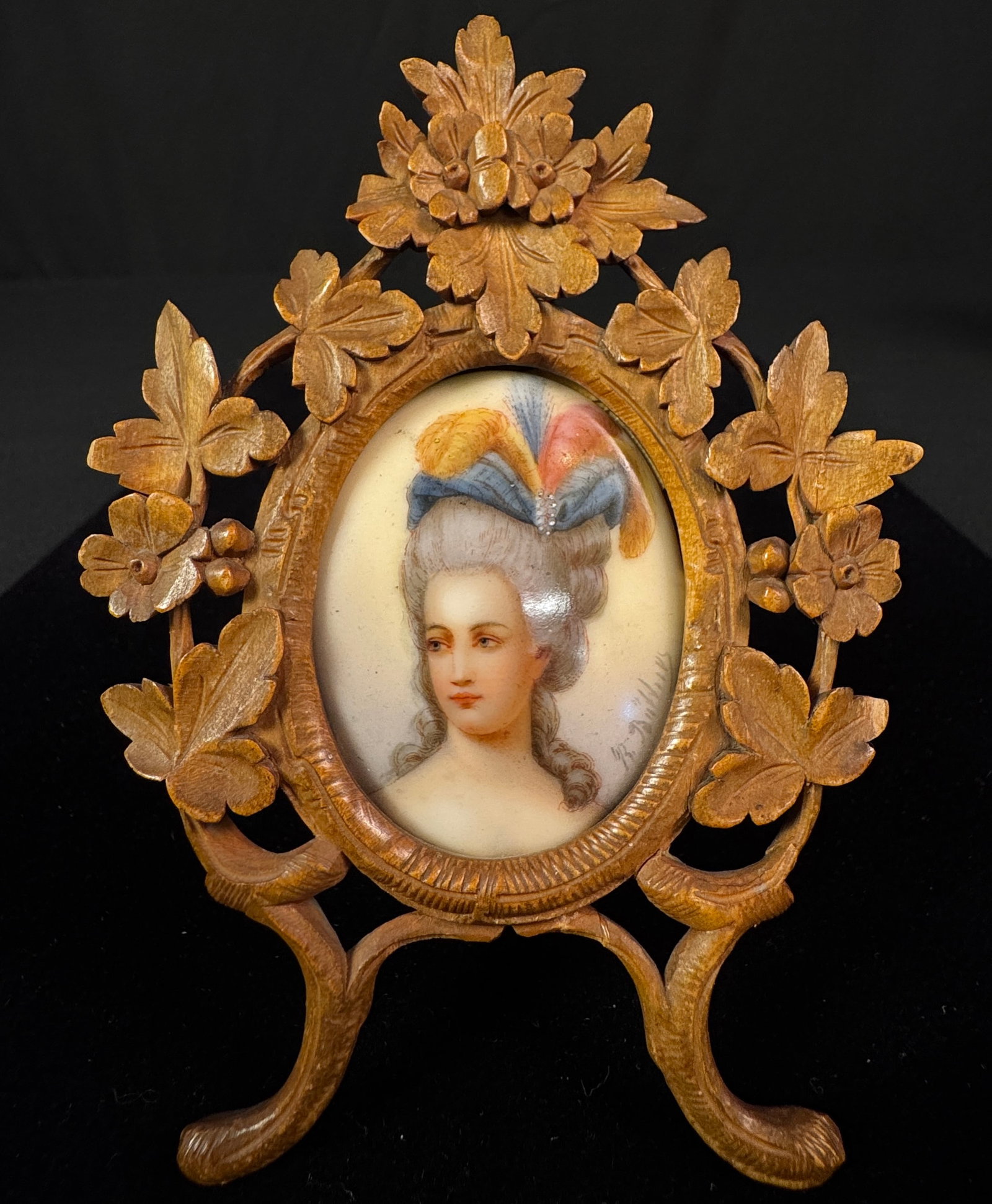 Victorian Porcelain Portrait in Ornate Carved Frame: A Victorian porcelain portrait of a French noblewoman, portrait is signed by artist. The porcelain is encased in an elaborately carved wooden Victorian frame. In very good condition, it measures 5.5" 