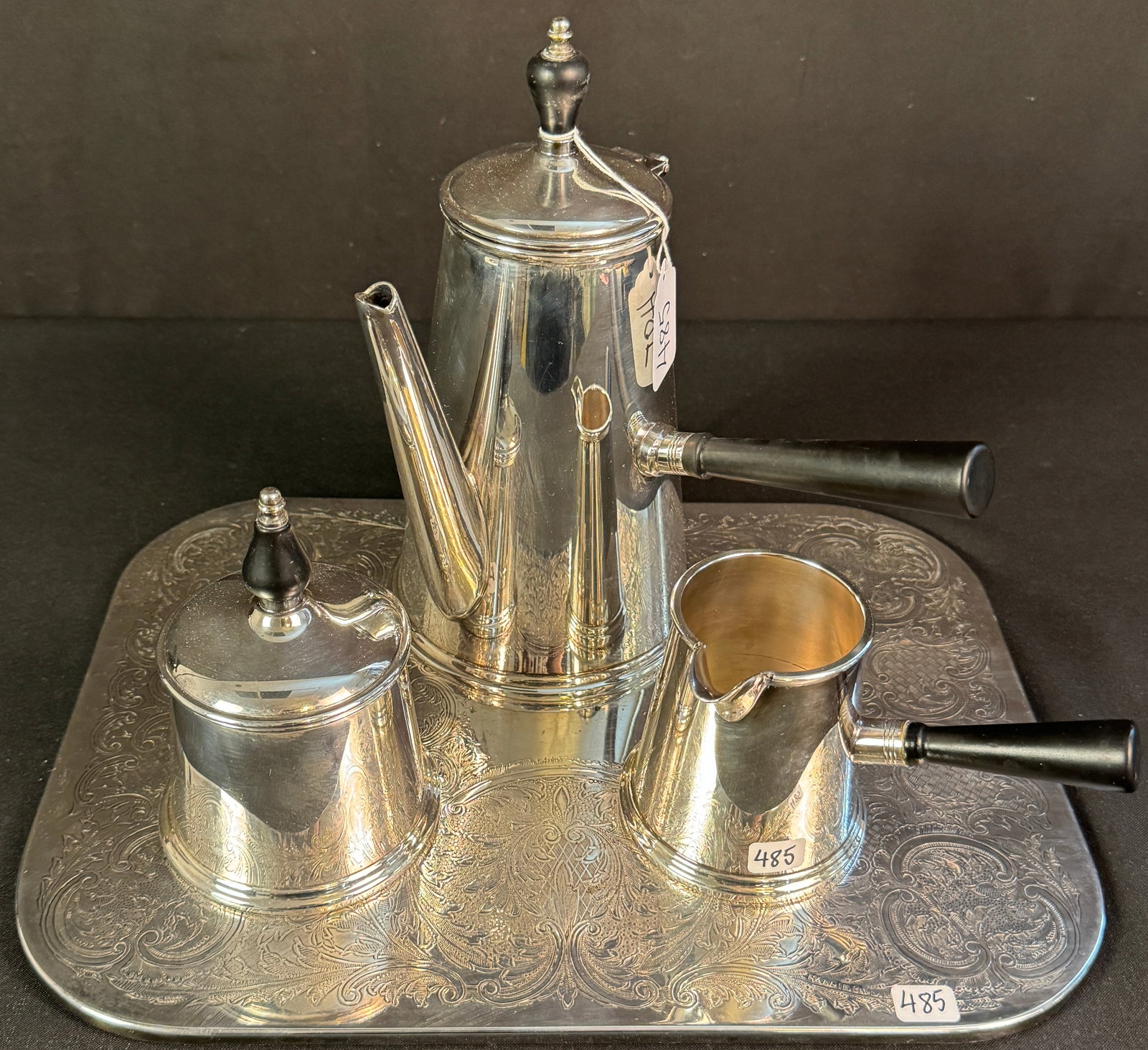 Sheffield Silver Co Coffee Set w/ Platter: A Sheffield Silver Co. silver plate coffee set with a filigreed rounded edge platter. The retro stylized set includes a coffee pot with ebony handle and finial, a covered sugar bowl with ebony finial,