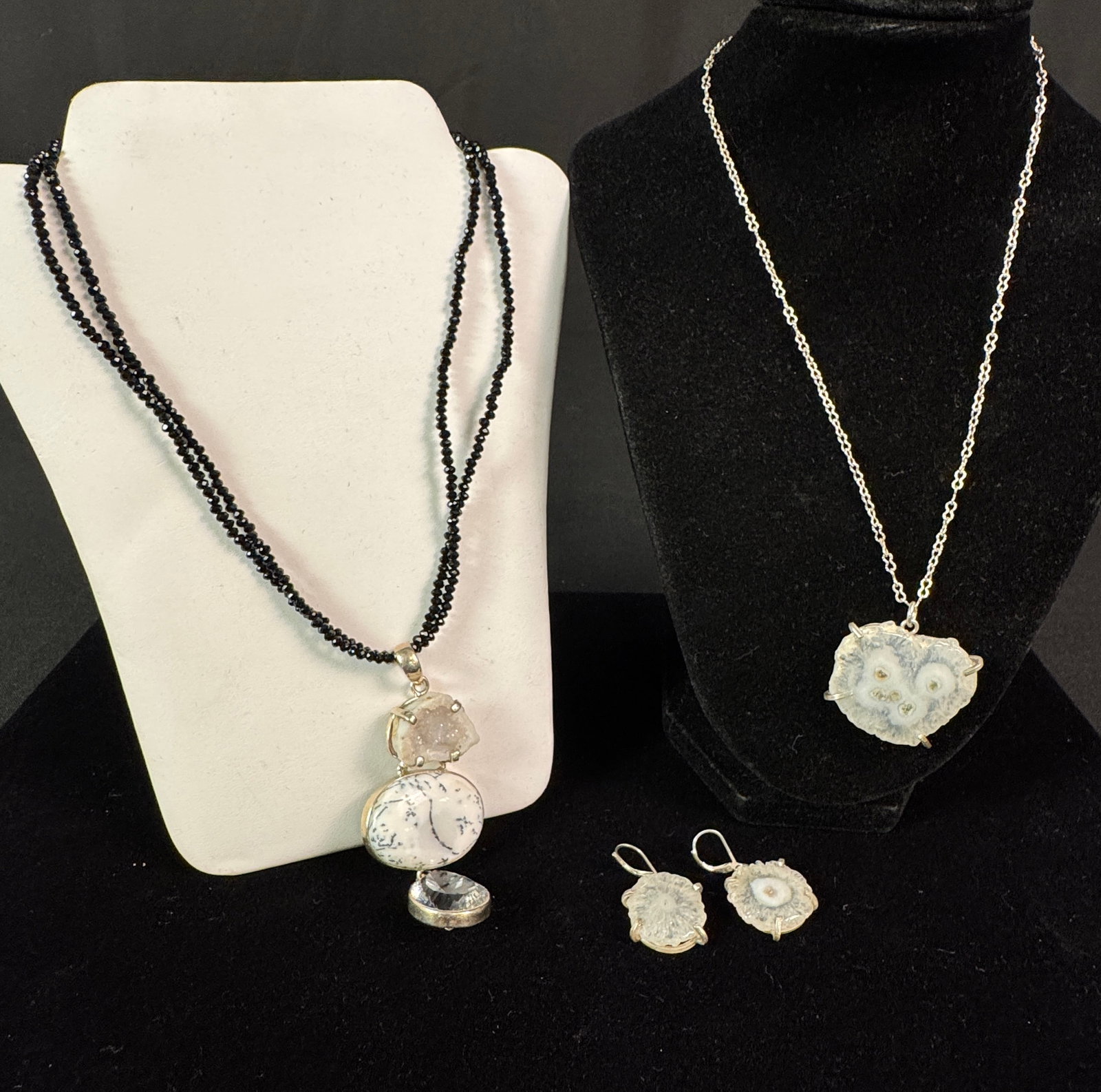Group of High Quality Stone Jewelry: A group of high quality stone jewelry to include a beaded cut garnet necklace with a large sterling pendant that features a rough cut geode, polished dendritic agate, and cut rock crystal pendant. Als