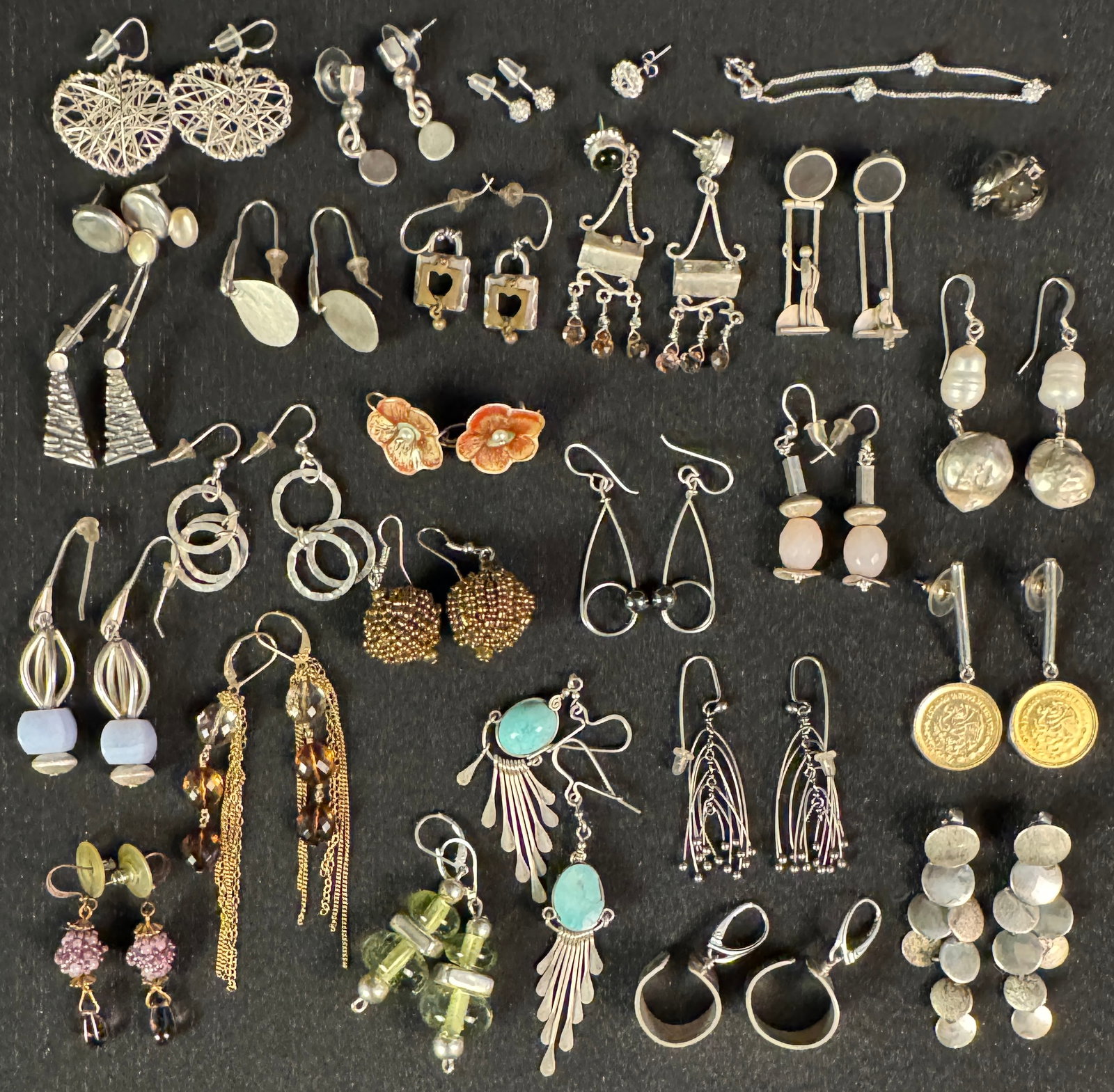 Large Group of Handmade Sterling Designer Earrings: A large group of handmade designer sterling earrings, some pieces are signed by artist, and feature a variety of stones, pearls, and colored glass. All in excellent condition.