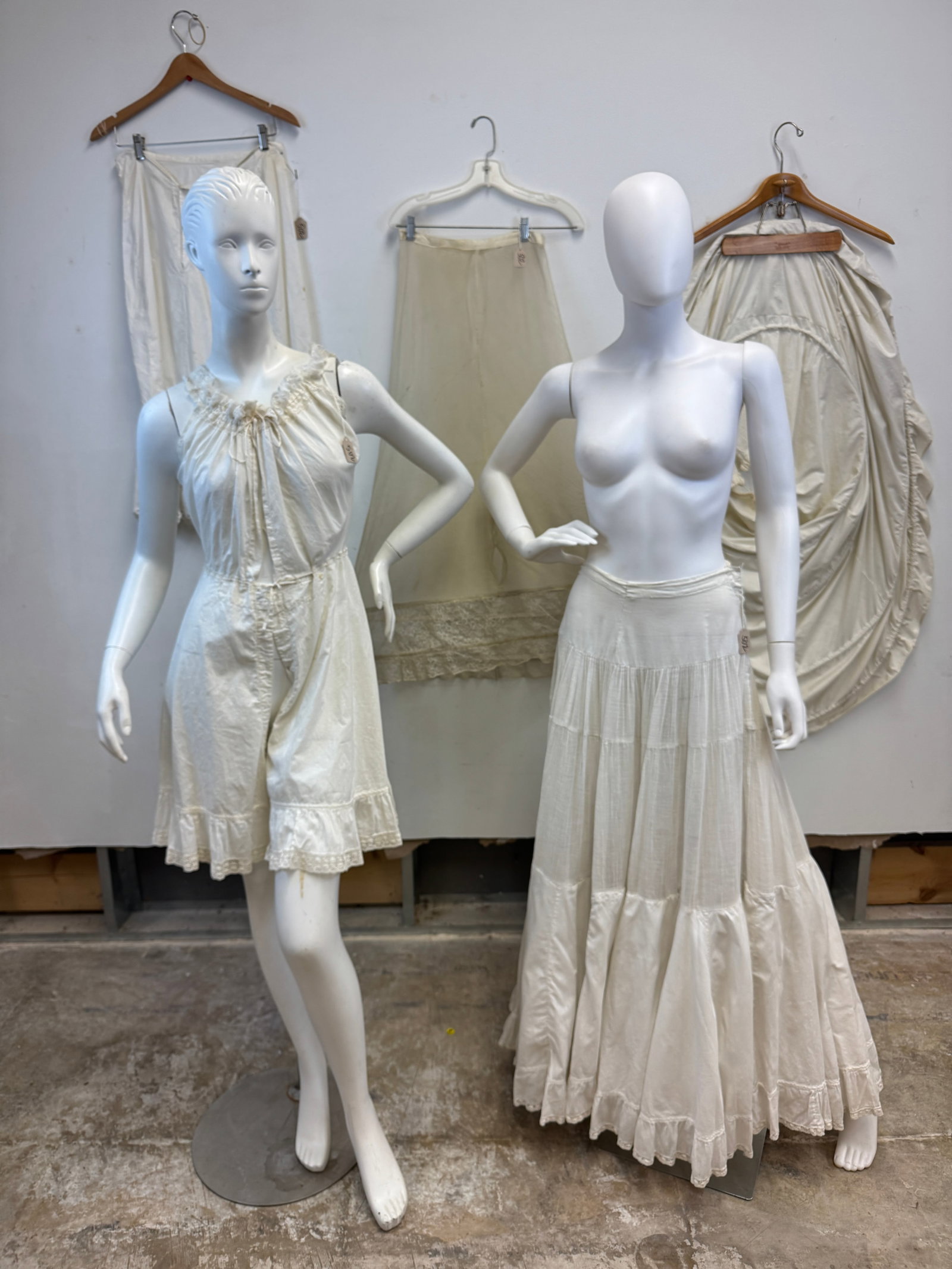 Antique Group of ladies Cotton Undergarments c1900: A group of antique white ladies cotton undergarments c.1900 to include a tiny ladies onesie with ruffled split crotch bloomers with ruffled trim, draw string waist and bust, and lace straps and neckli
