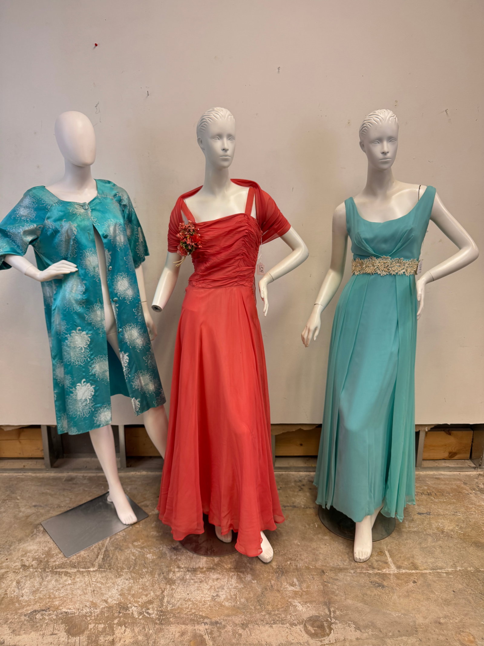 Vintage Evening Gowns and Coat c.1950's: A group of vintage 1950's veining wear to include a coral sleeveless veining gown with pleated skirting and floral corsage in excellent condition, a diaphanous turquoise empire waist sleeveless gown w