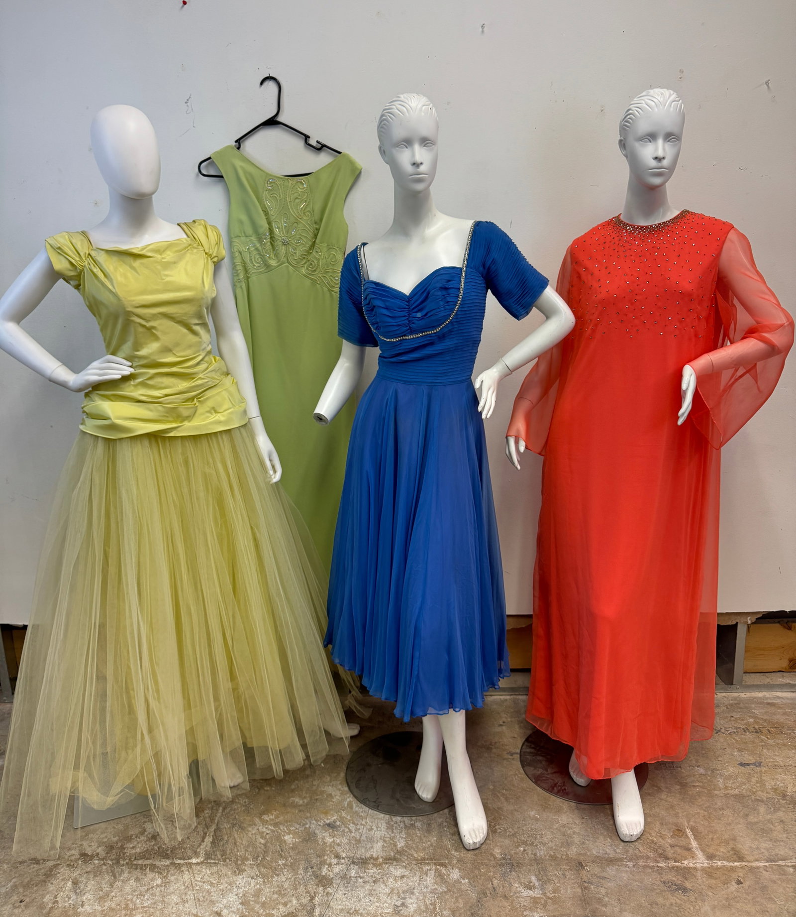 Ladies Vintage Evening Gowns C.1950/60's: A group of ladies evening gowns c.1950/60's to include a yellow fit and flair formal gown with layered net full skirt and wrap peplum in excellent condition, a blue fit and flair plated blue chiffon