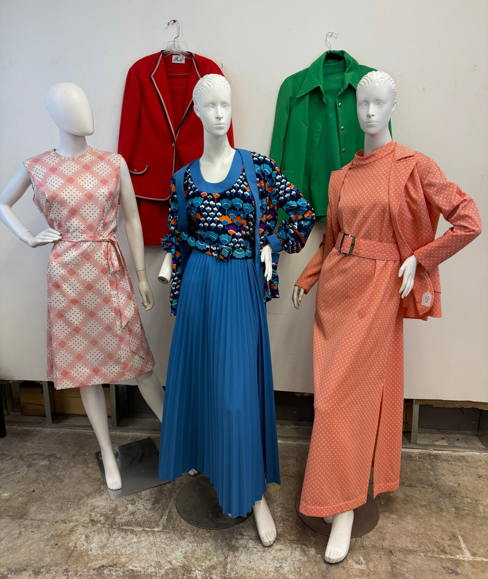 Group of 1970's Poly Patterned Dresses: A group of vintage 1970's dresses to include a Saks Fifth Avenue blue maxi dress that features pop art floral top and matching jacket, belt and long pleated skirt, a sleeveless Orsini dress with a red
