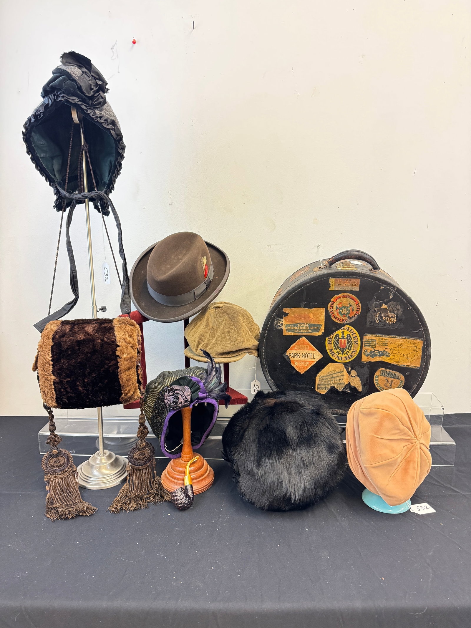 1920's Hatbox Suitcase, Hats and Muffs: A 1920's hatbox suitcase with original travel stickers, vintage hats to include a Lilly Dache Dachette velvet hat, a Victorian winter bonnet, a Jonathan Richard brown velvet pageboy hat, a men's