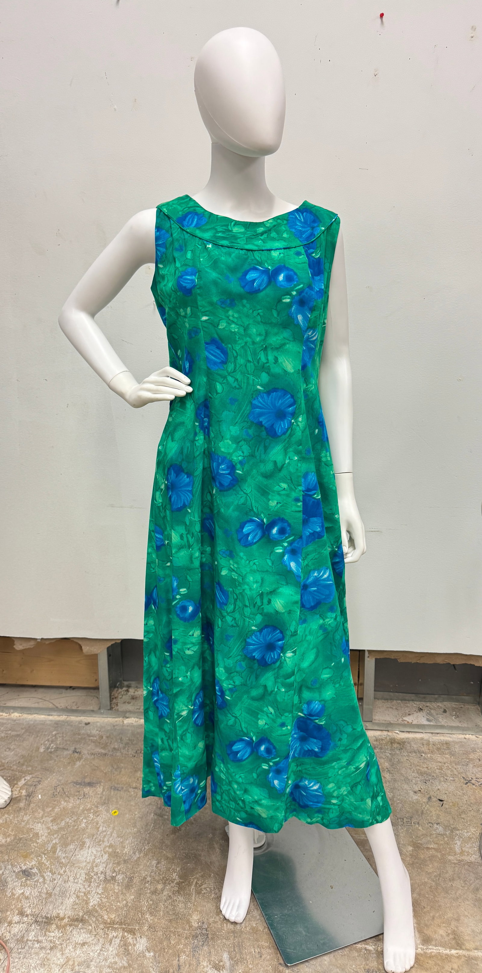Vintage Hawaiian Dresses C1960's: A vintage group of Hawaiian print dresses to include two blue Ui-Maikai sleeveless cotton baby doll style dresses that feature traditional drum and tiki floral prints, a green floral Royal Hawaiian