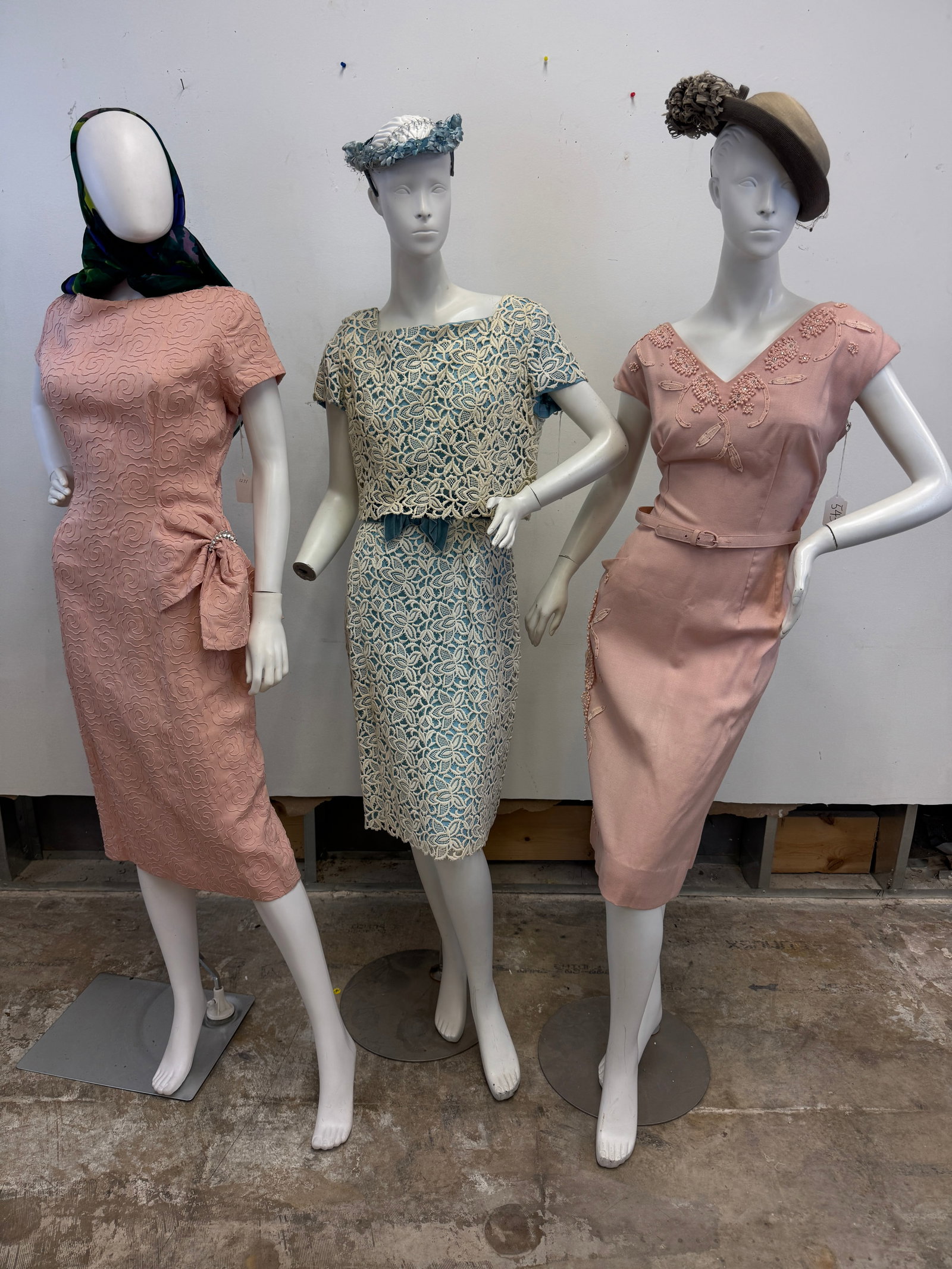 3 Fitted 1950's Party Dresses: 3 Vintage fancy ladies dresses c.1950's to include a pink fitted linen dress with a side bow and stylized floral embroidery, a sleeveless pink linen fit and flair dress with floral applicates and rhin