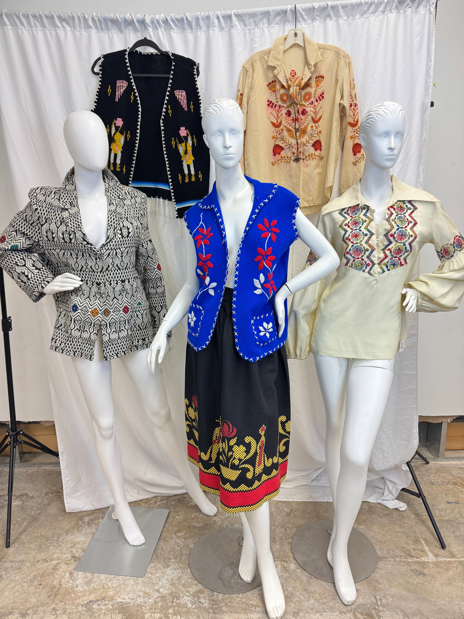Vintage Ethnic Style Clothing C1960's: A group of vintage ethnic clothing to include a woven geometric black and white pattern Central American jacket with flashes of green, red and gold in x. ceoend., 2 knit wool vests with floral and fig