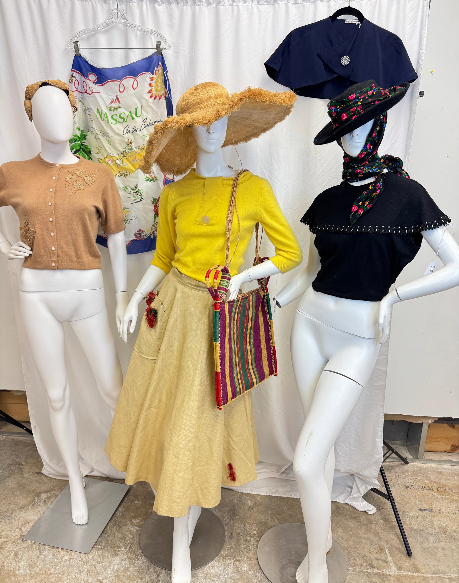 Group of 1950's Sweaters, and Accessories: A group of ladies vintage sweaters and accessories c.1950's to include a midnight blue ladies capelets, a short sleeve 50's orlon Suart Lloyd beige sweater with rhinestone floral applicates, a yellow 