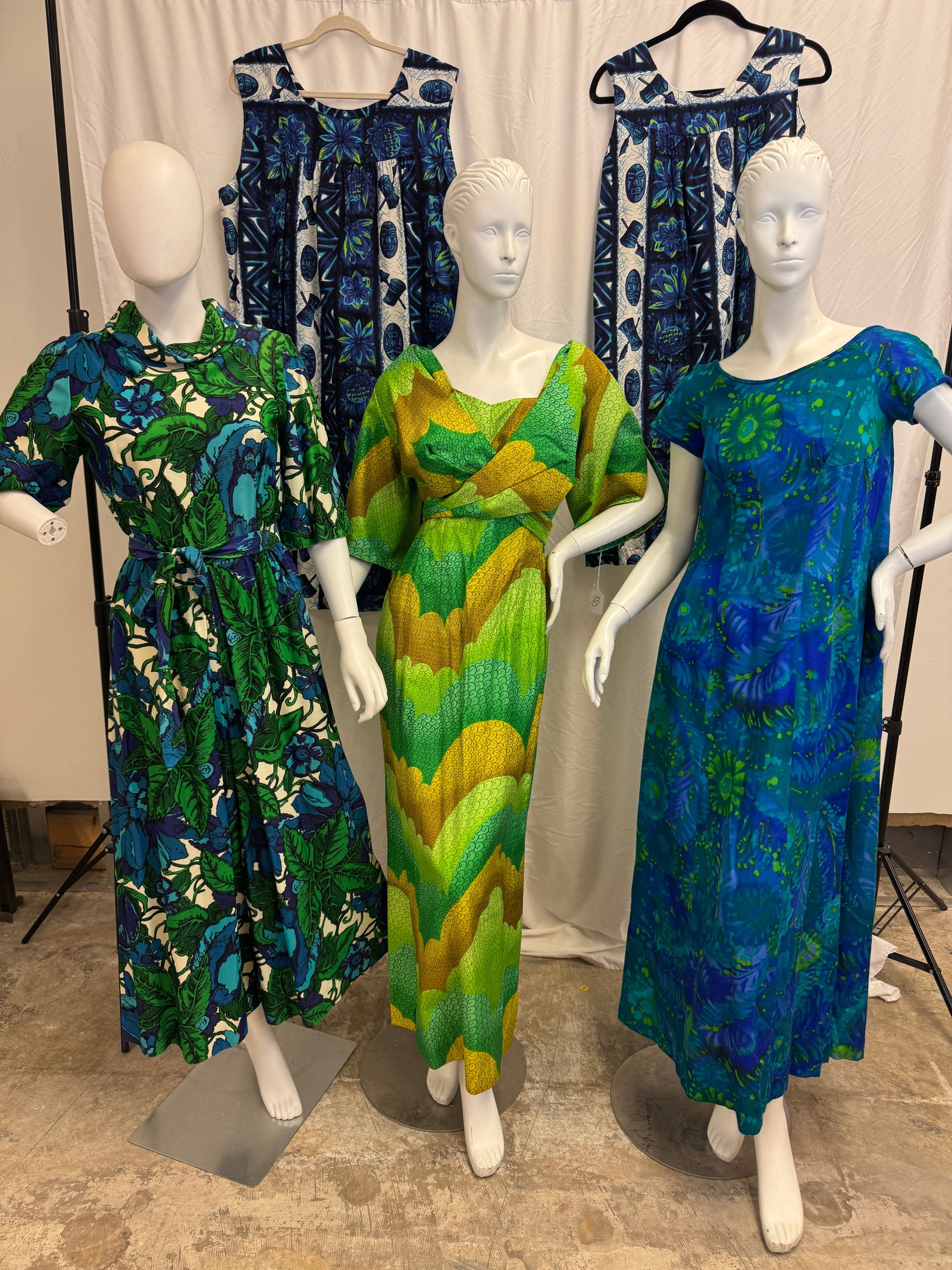 Group of Vintage Hawaiian Dresses, More!: A group of vintage 1960's Hawaiian dresses to include a dead stock cotton Hawaiian togs for McInerny full length dress with a wrap top and green wave printed fabric, a blue and green floral pantsuit b