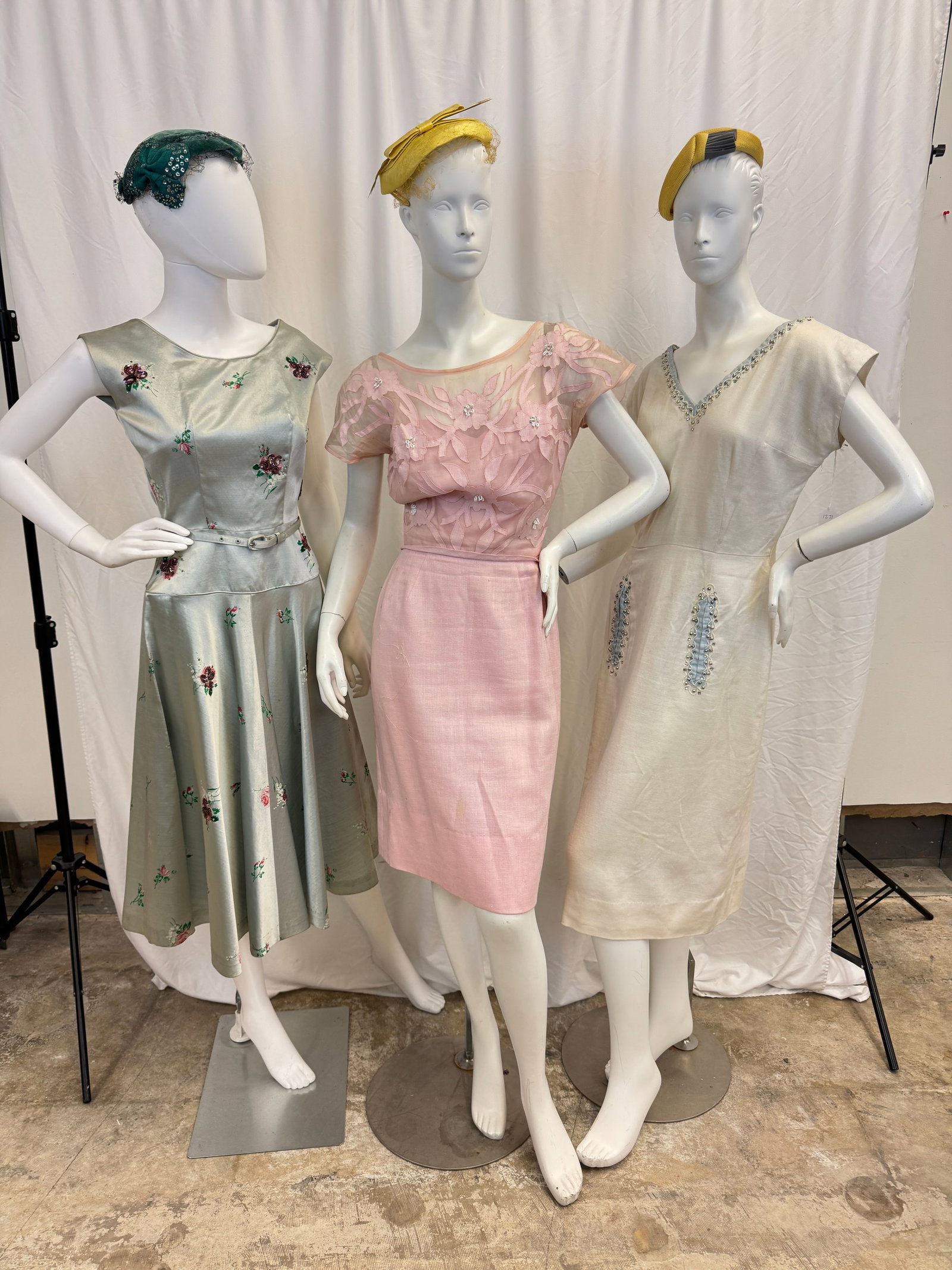 3 Fancy 1950's Ladies Dresses: Three vintage ladies 1950's dressy dresses to include a pink fit and flair dress with sheer bodice overlay with beaded floral applicates (small hole in armpit noted), a Doris Dodson silvery blue satee