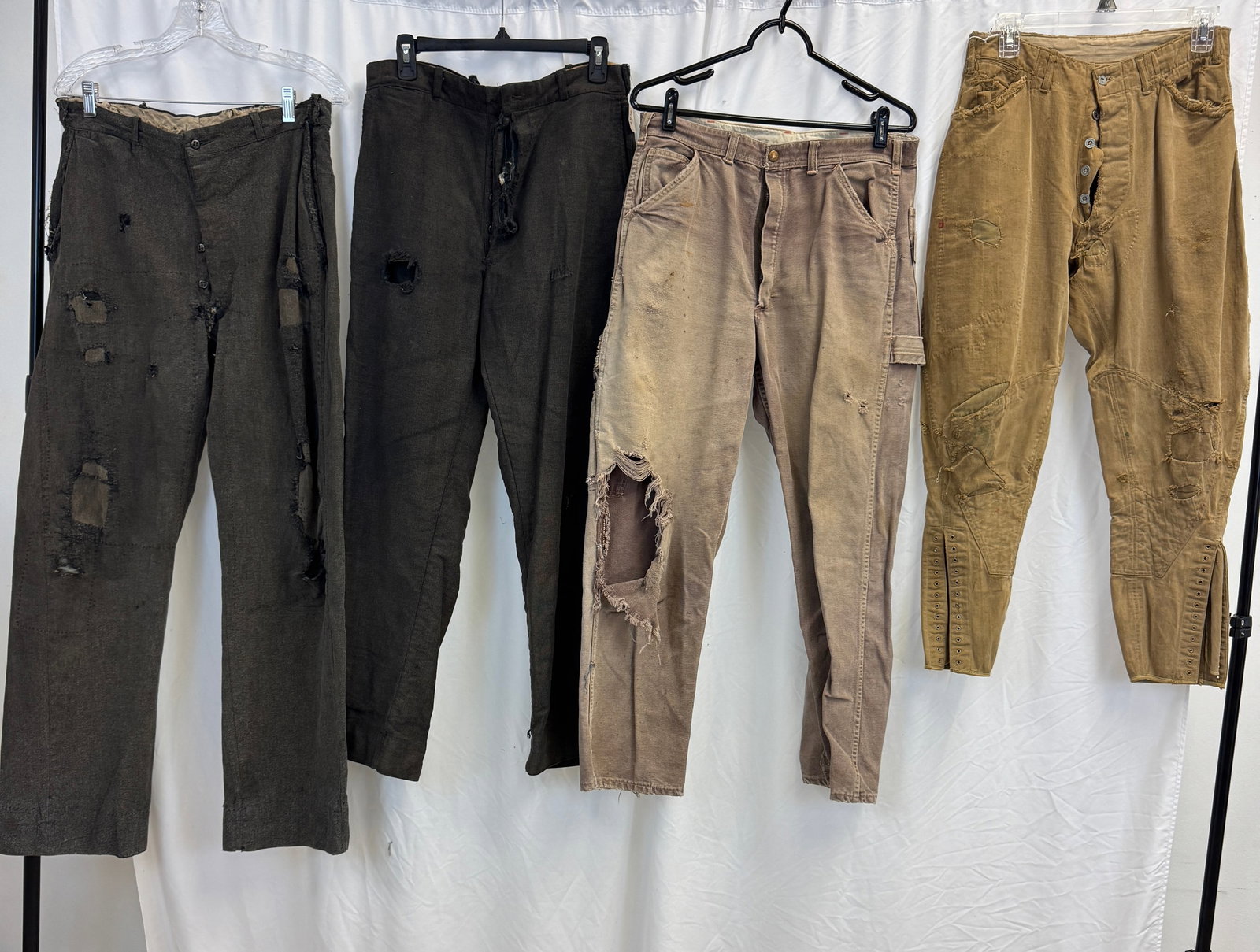 Vintage Men's Trousers C 1900-1940: A vintage group of men's trousers to include 1920's riding pants 30 " waist with many repairs, 34" waist turn of the century grey button fly trousers with many repairs and holes, a pair of 30" waist