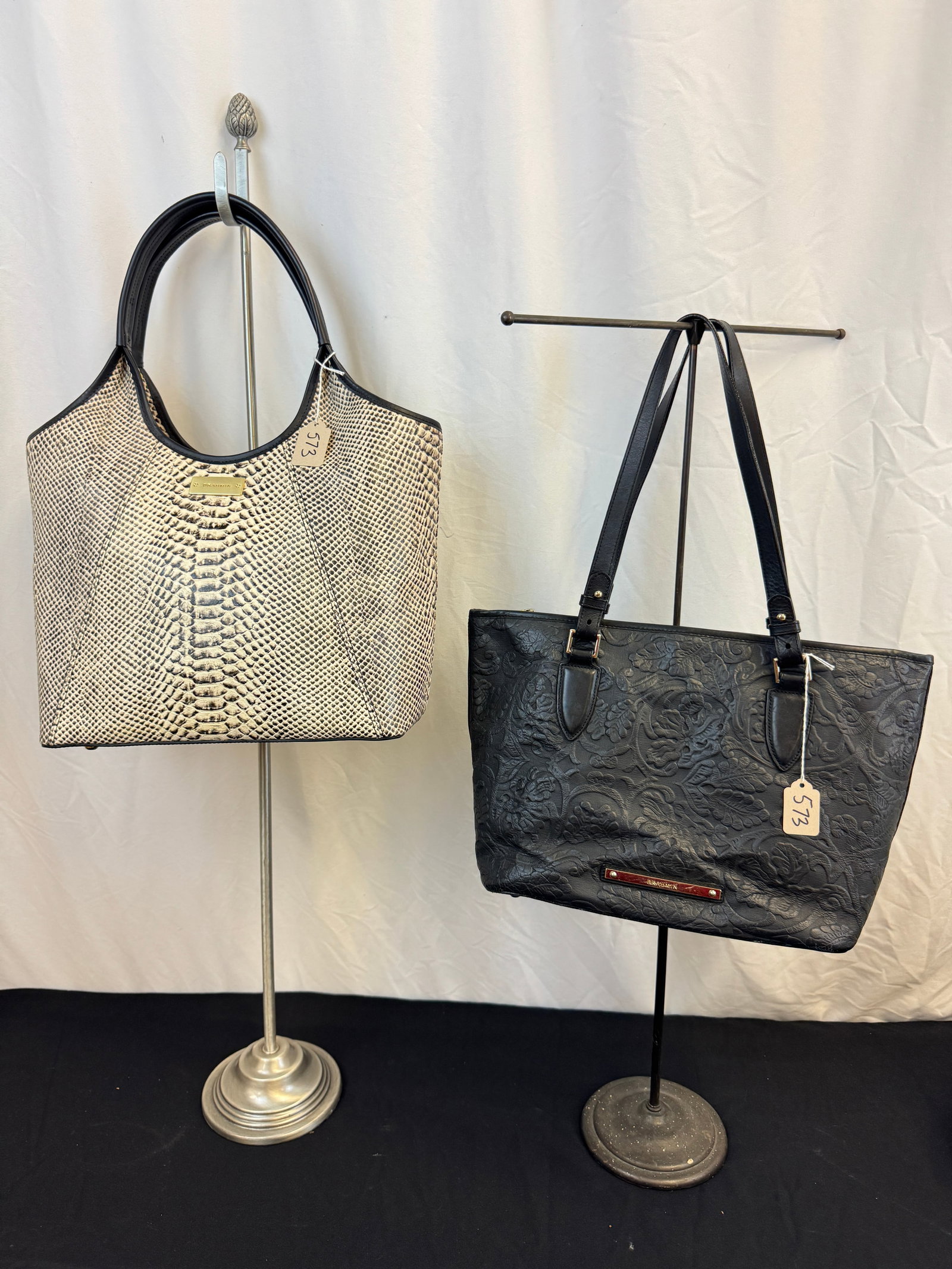 2 Brahmin Leather Handbags: Two contemporary leather Brahmin handbags in excellent condition to include a leather stamped snakeskin patten handbag with black leather accents that measures 18" tall X 14" across. Also included is