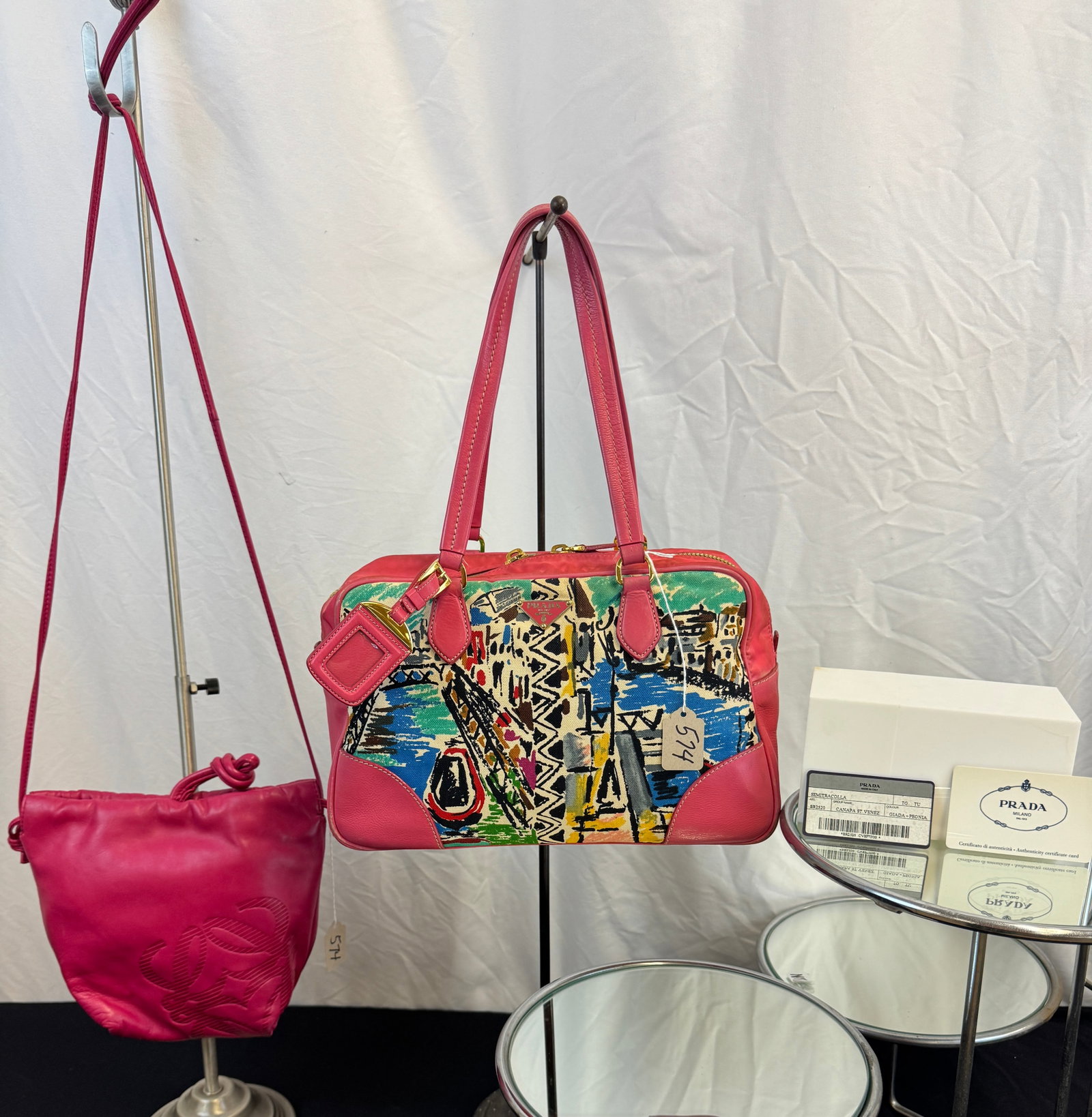 Vintage Prada and Loewe Purses: 2 Vintage Designer bags to include a fuchsia Loewe leather Anagram drawstring bag in excellent condition, and a Prada Canapa St, Venez handbag with bright pink leather trim along with it' Prada card o
