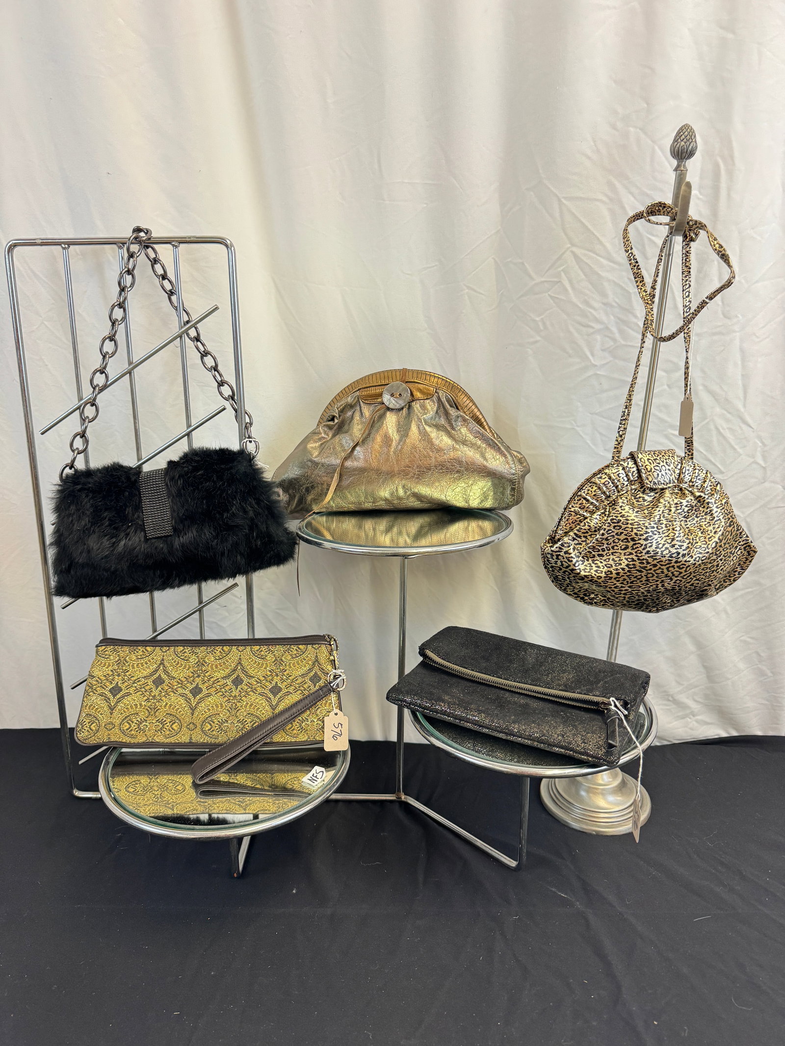 Vintage Group of Metallic Purses: A group of vintage 80's and 90's metallic purses to include an Italian Studio one leopard printed gold leather shoulder bag, an Arto New York iridescent metallic leather clutch, a black fur Sondra Rob