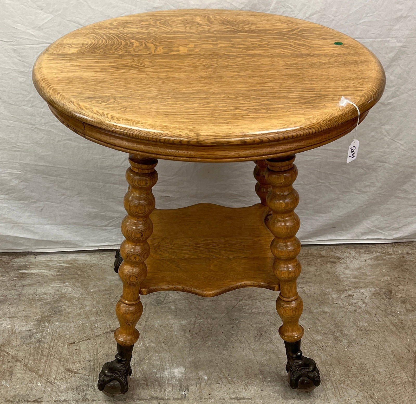 Parlor Table w/ Exaggerated Claw Feet: A round parlor table with exaggerated claw feet, with glass ball feet. In excellent, house ready condition, it measures 30" tall X 27" round.
