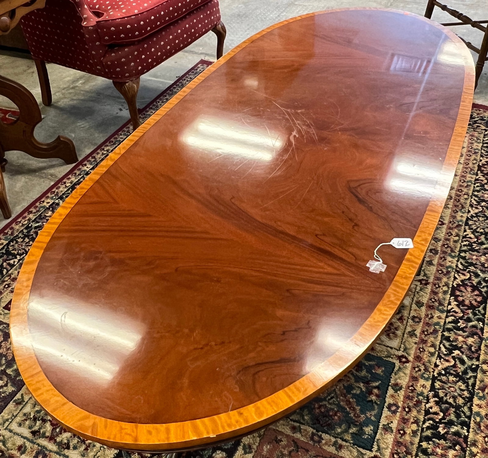 Large Mahogany Coffee Table: A large flamed mahogany coffee table with banded inlay in the shape of a federal-style dining table. In excellent, original French finish (with marks in the French polish that can be easily buffed