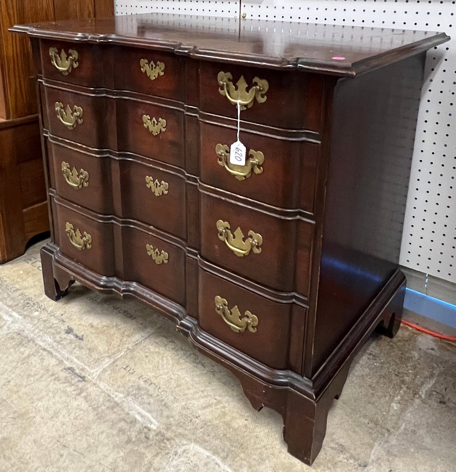 Chippendale Block Front Chest of Drawers: A 1920/1930 mahogany four-drawer block front chest w/ a serpentine front and bracket feet. This chest was made by the Henry Ford museum. In original finish, it measures 31" tall 36" across X 21" deep.