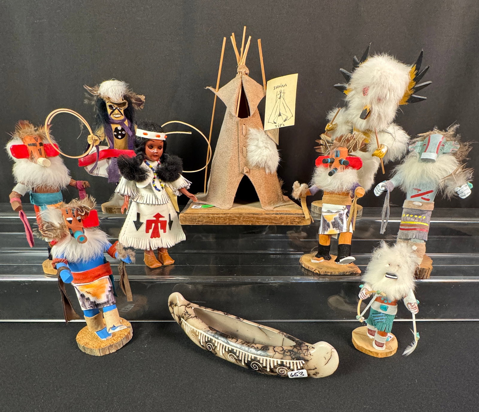 Group of Signed Hopi Kachina Dolls, More!: A group of signed Hopi Kachina dolls to include five 7" tall kachina dolls, a 9" tall owl doll signed V. T. Kirk, an unsigned 5' tall warrior, a signed clay canoe, an 11" tall hide tipi on a wood