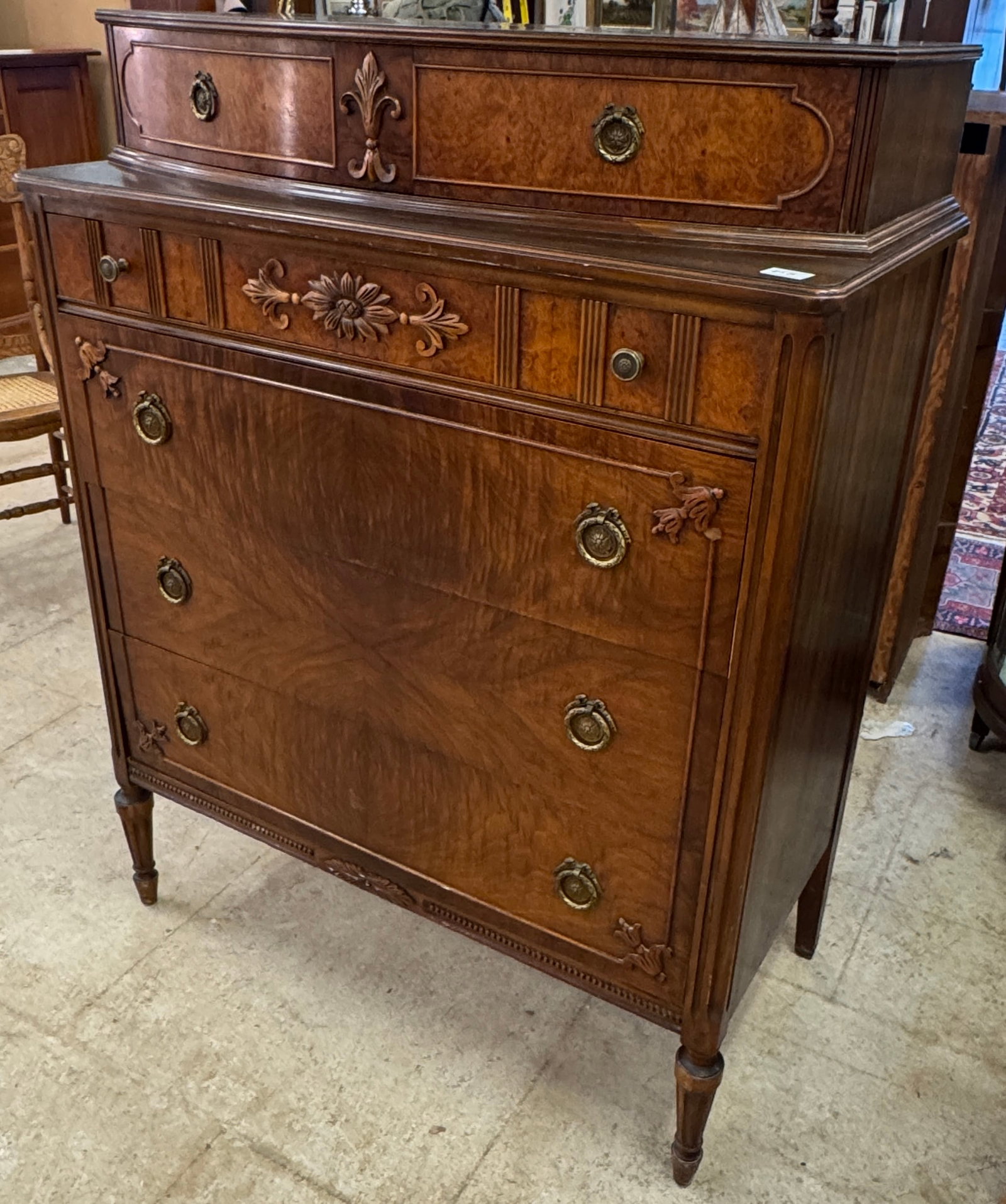 Symmons Mahogany 5 Drawer Dresser c1930's: A Symmins mahogany 5 drawer dresser c1930's that features book matched drawer fronts, floral and flor de lis carvings, fancy brass pulls, and turned legs in good condition.