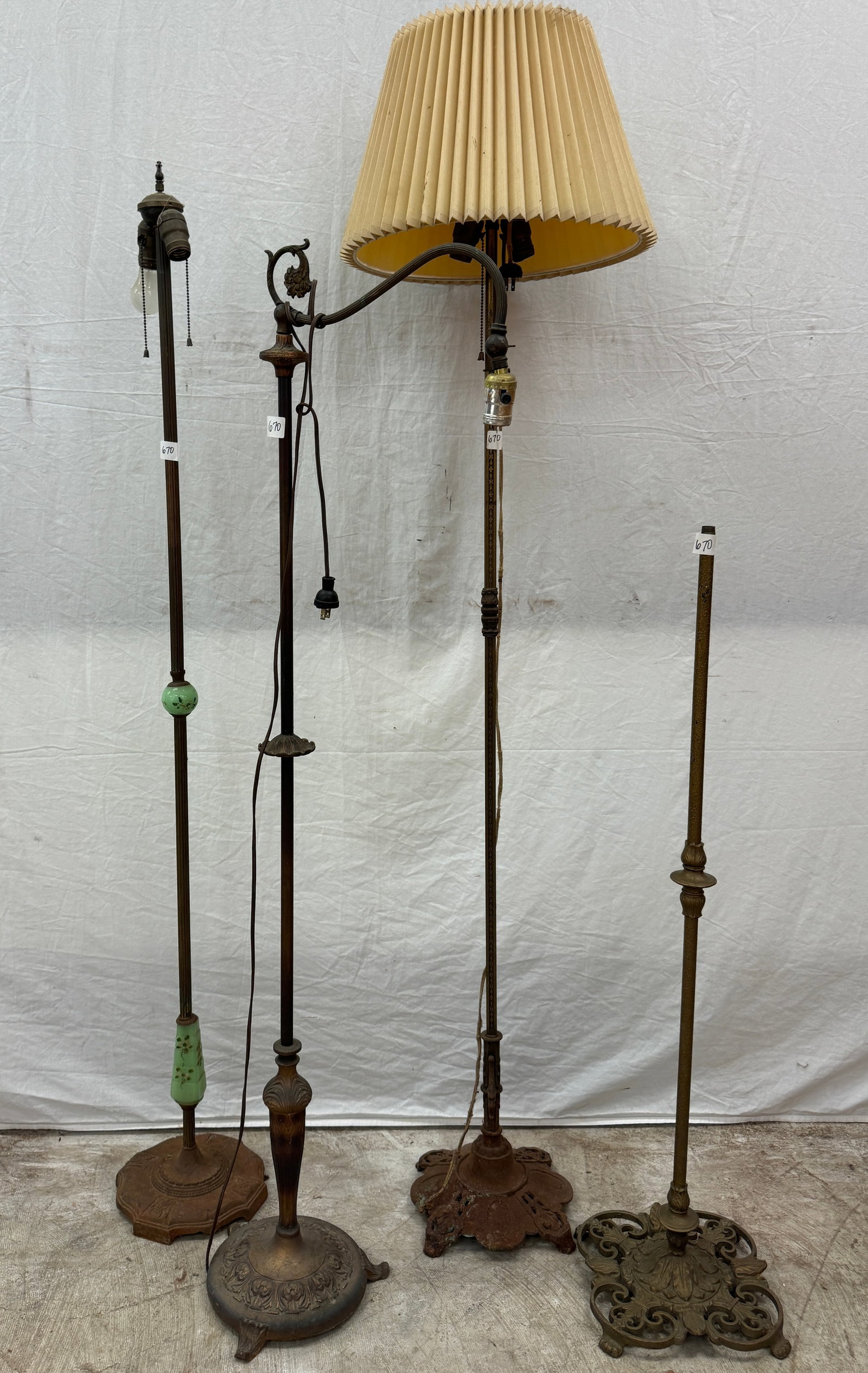 Group of Iron Floor Lamps: A group of 4 antique floor lamps in need of rewiring and restoration to include one with slag glass balls, ornate bases, one with a filigreed brass pole, and one missing it's upper half.