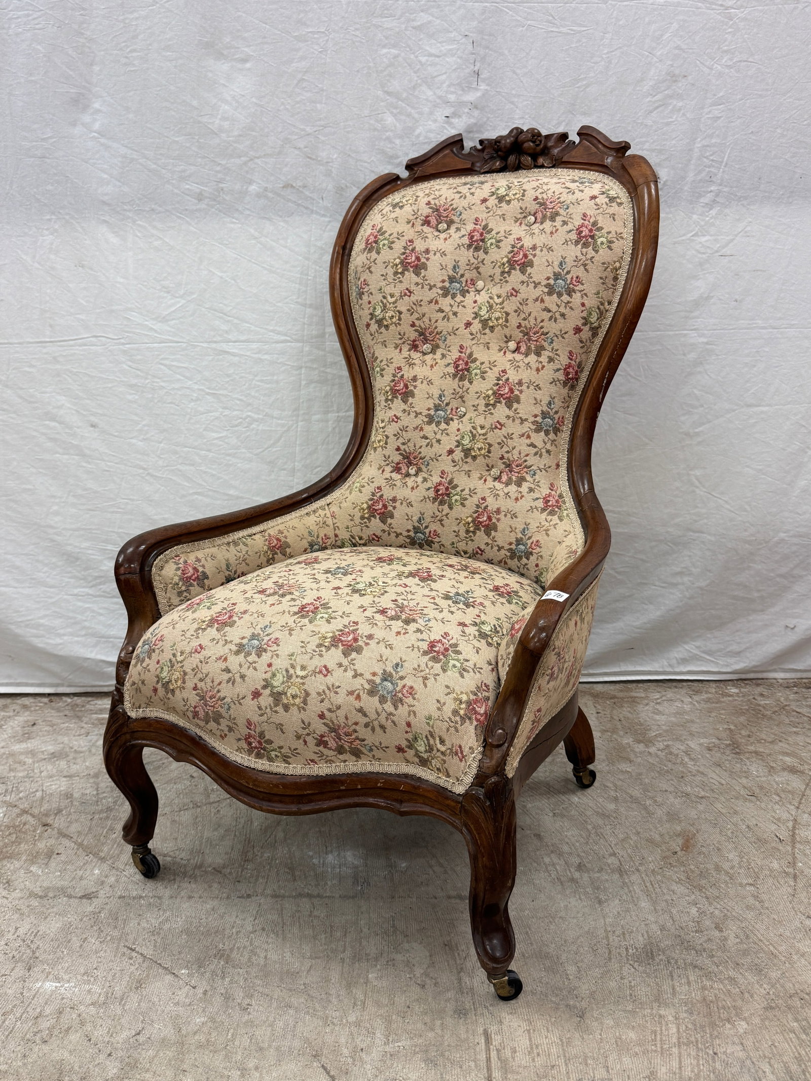 Mahogany Victorian Slipper Chair c.1880's: A Victorian mahogany upholstered slipper chair with fruit carved frame and cabriole legs that features rose pattern fabric on bronze castors in very good condition.