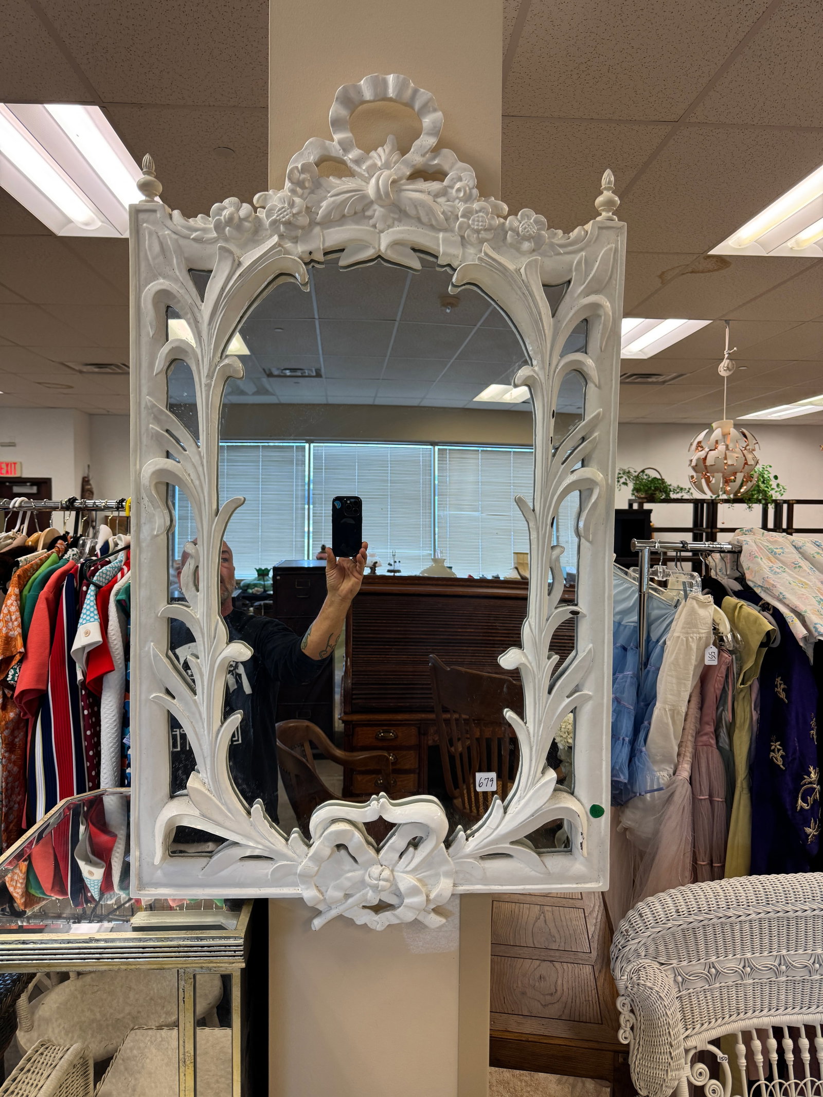 Fancy Victorian Style Mirror: A Victorian style white painted fancy framed plaster mirror that features leaves, finials and garland accents.