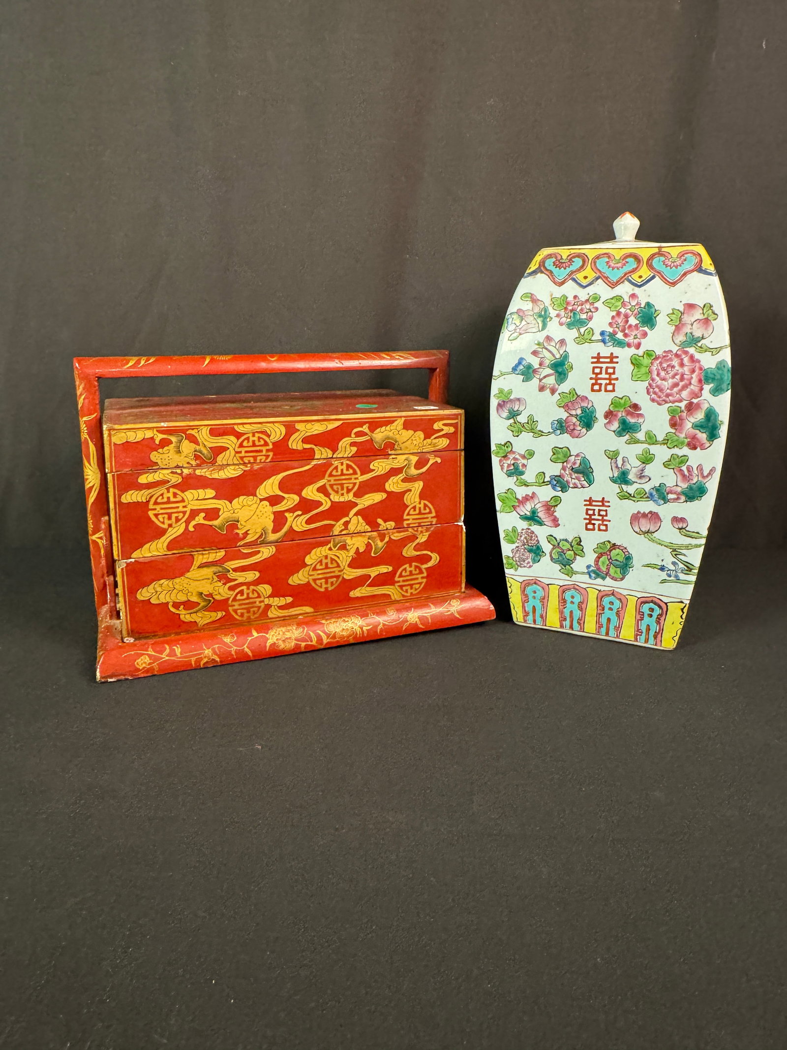 Chinese Familie Rose Porcelain Lidded Jar, Red Lacquered Lunch Box c1940's: A poly chrome porcelain floral painted 4 sided lidded jar, signed on bottom, 20th Century that measures 14" tall X 7" X 7" in excellent condition, and a red lacquered lunch box c1940's and 2