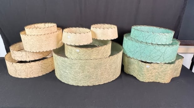 Group of 50s Atomic Lamp Shades: A group of seven 1950s atomic fiberglass lampshades, to include a 2-tiered turquoise, a 2-tiered cream, and others. All in good condition.