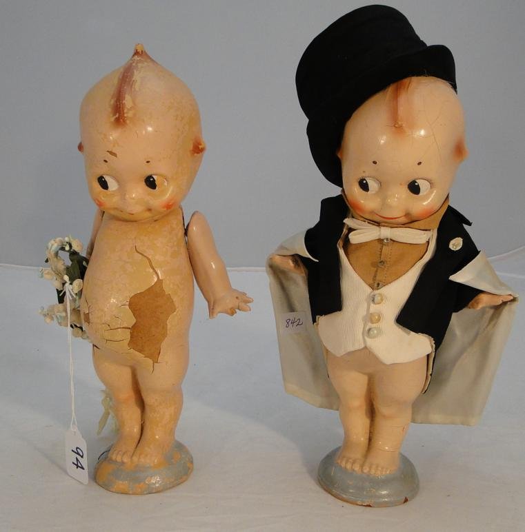 A papier mache Kewpie bride and groom with Rose O'Neil: A papier mache Kewpie bride and groom with Rose O'Neil 1913 stickers on base, measure 12" tall