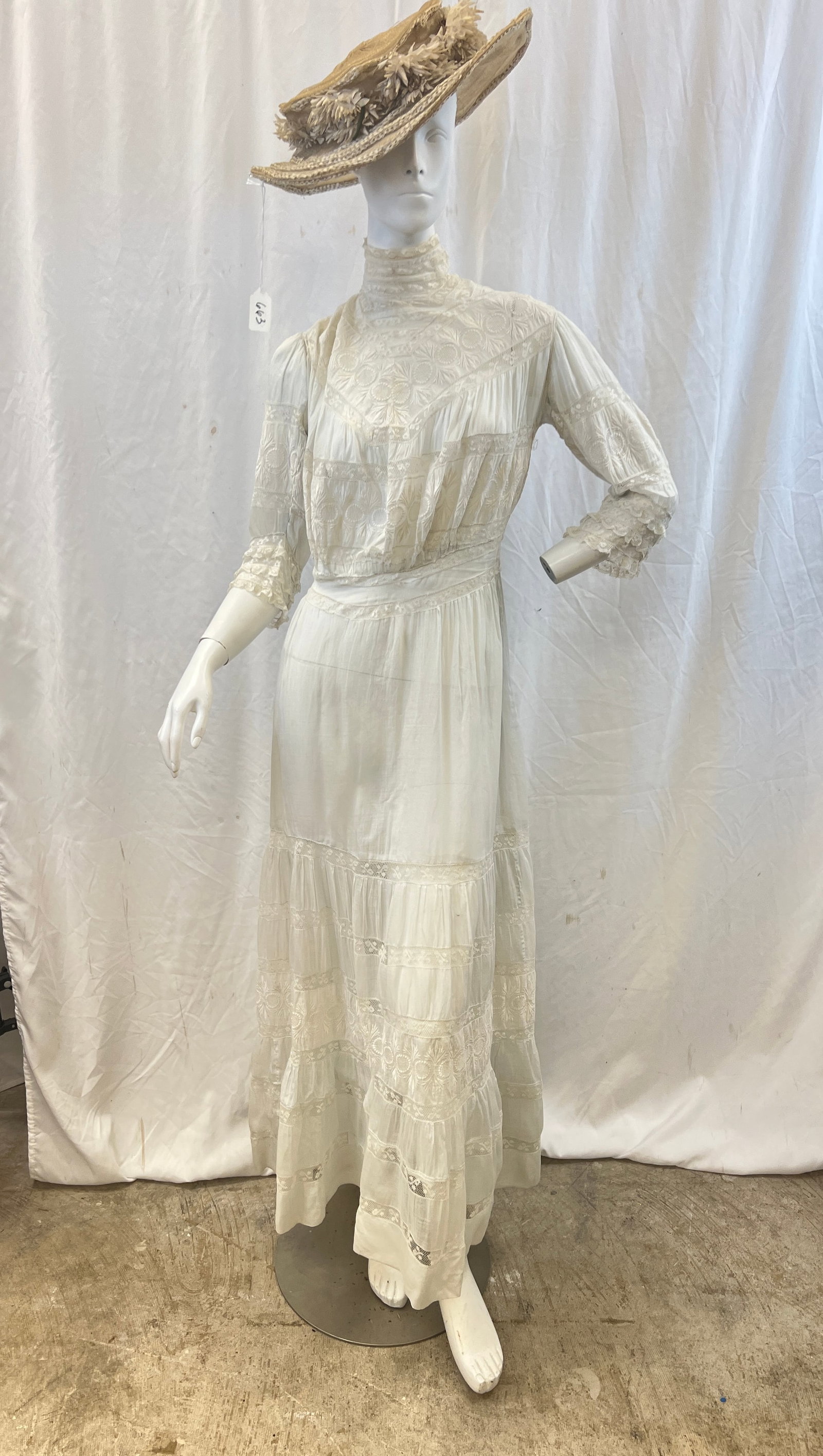Victorian White Lace Cotton Lawn Dress and Matching Hat c.1900: A Victorian white cotton lace lawn dress that features long sleeves with lace ruffles, high kneck, and floral embroidered yoke , in excellent condition. Also included is a matching straw hat with silk