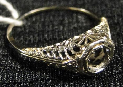 Elaborate 1920s filigreed wedding band in white 18k: Elaborate 1920s filigreed wedding band in white 18k gold. This stunning wedding band has room for a 1.5k diamond. This band weighs 2g.