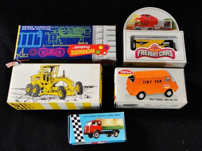 A Catepillar motorgrader, a miniature Tiny Tonka van: A Catepillar motorgrader, a miniature Tiny Tonka van #531, a hemi penny auto carrier miniature truck, a WFE miniature tractor, a miniature freight train, and a Pabst brewery box car, all in original p