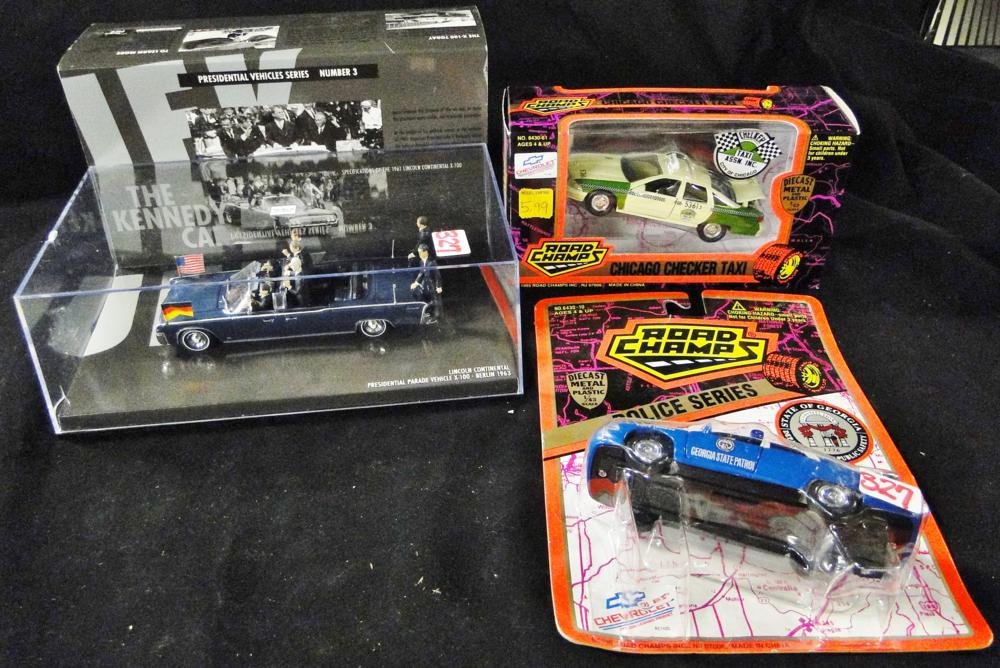 Road Champs diecast police car along with a Road Champs: Road Champs diecast police car along with a Road Champs diecast checkered Chicago cab and a Kennedy presidential Lincoln Continental convertible in a case with packaging.