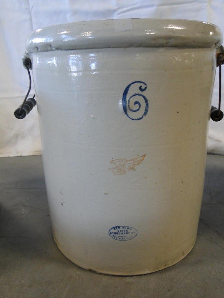 A six gallon Red Wing bale handled crock. Signed with: A six gallon Red Wing bale handled crock. Signed with miniture Red Wing in good condition. It also has a patent date of December 2nd, 1915. It measures 15" tall by 13 1/2" across