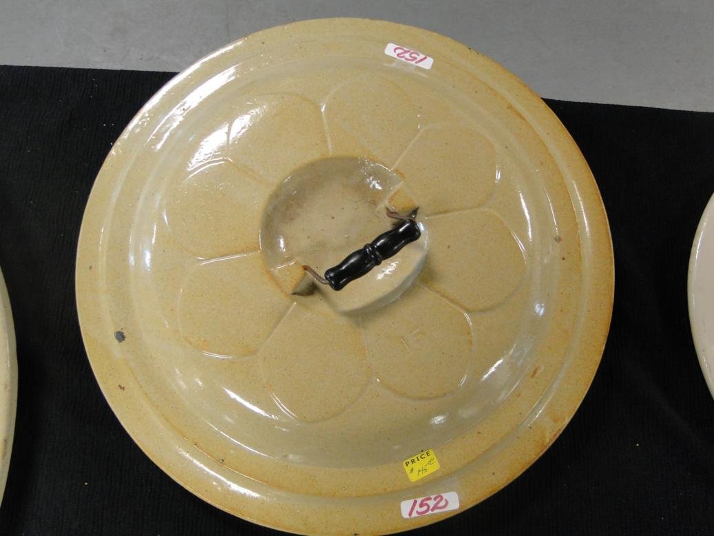 A Red Wing 15 gallon crock cover which retains its: A Red Wing 15 gallon crock cover which retains its original bale handle in great condition with molded petal decorations. It measures 18" across.