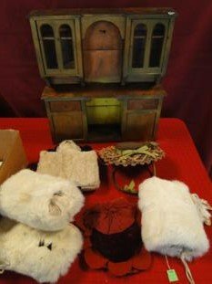 A folk art turn of the century doll cupboard along with: A folk art turn of the century doll cupboard along with turn of the century doll hats and fur muffs.